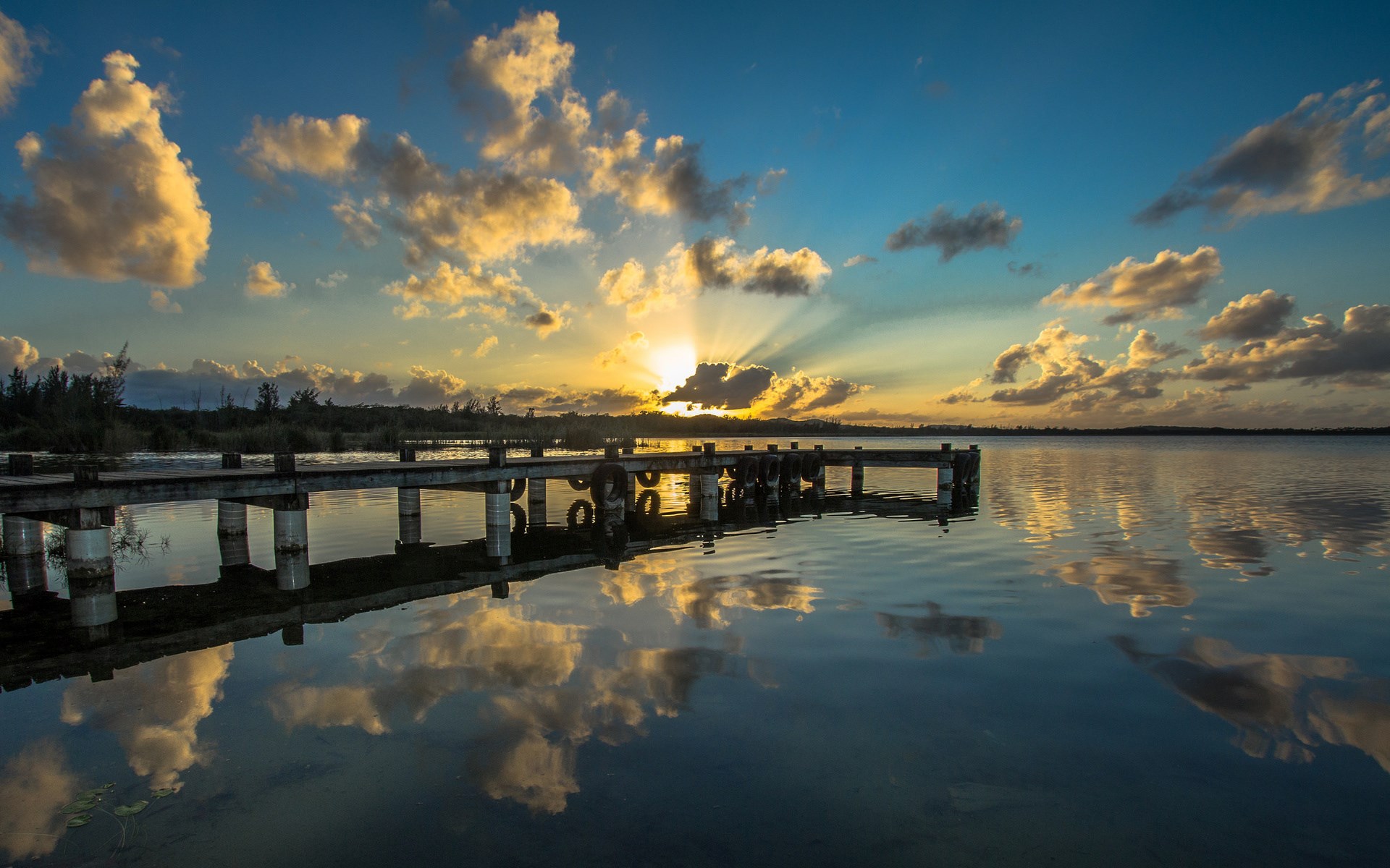 Sunrise over a lake with a wooden pier HD Wallpaper