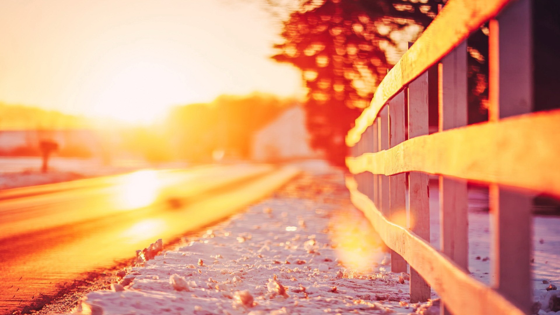 Winter sunset over a snowy road with a wooden fence HD Wallpaper