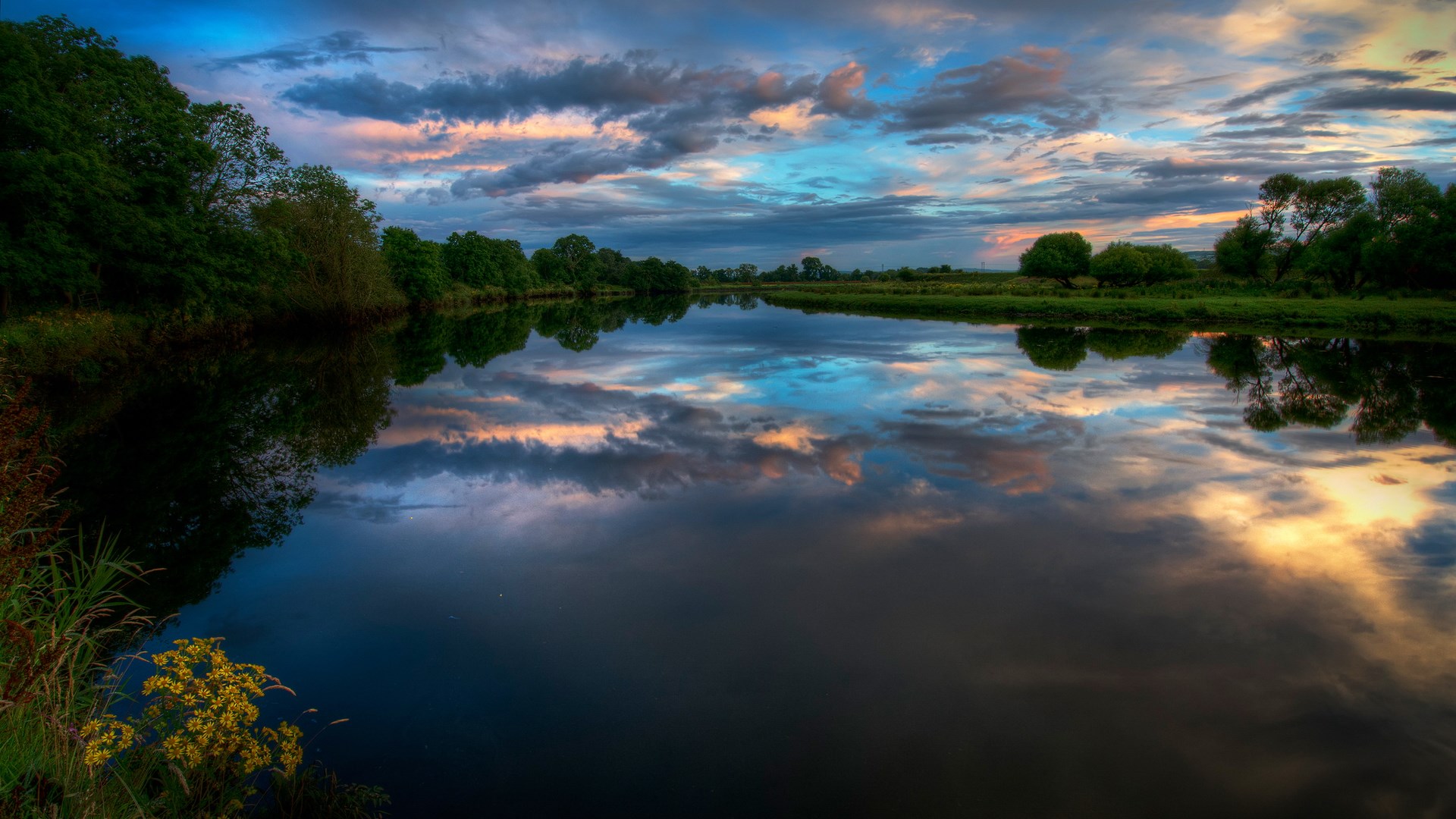 Sunset clouds reflected in a calm river with trees HD Wallpaper