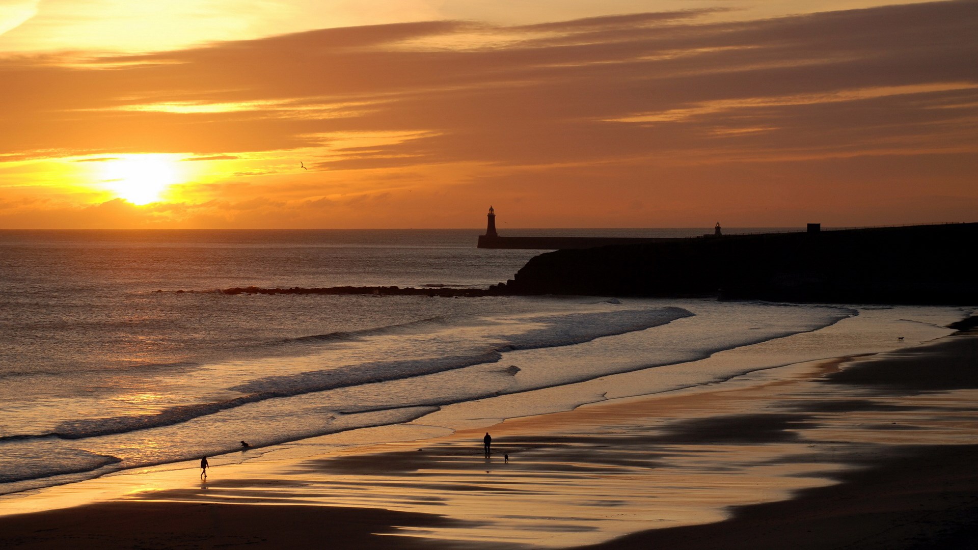 Sunset over the ocean with a lighthouse HD Wallpaper