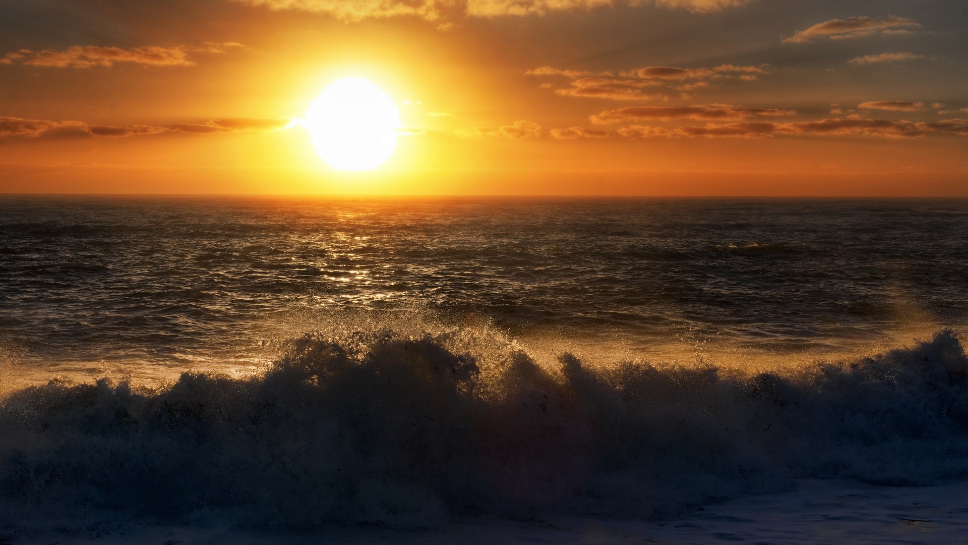 Sunset over the ocean with waves HD Wallpaper
