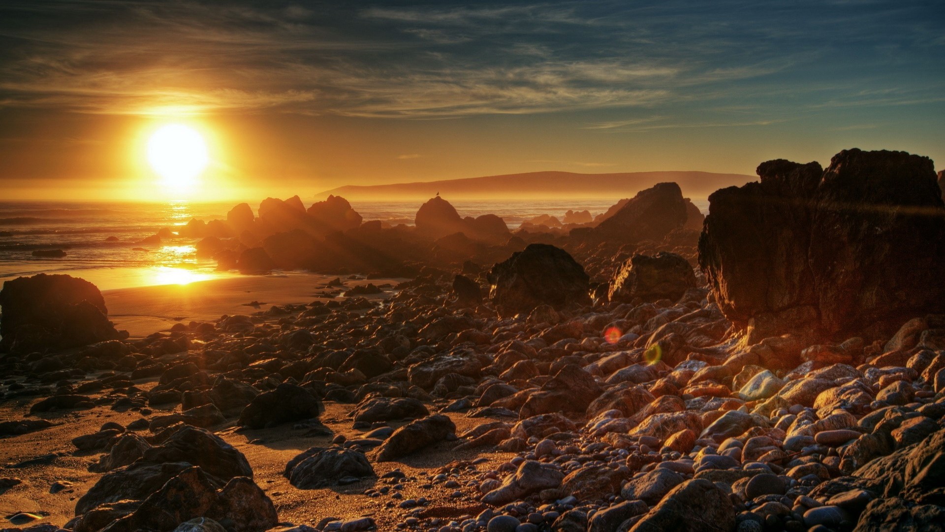 Sunset over rocky coastline with ocean waves HD Wallpaper