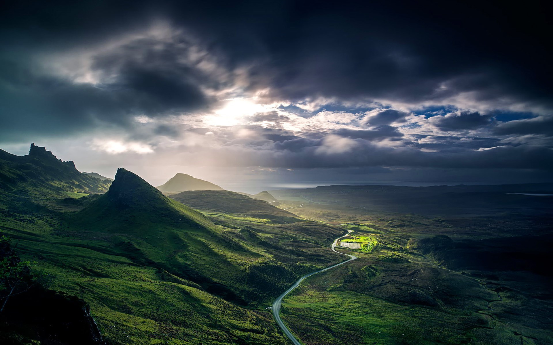 Dramatic landscape with rolling green hills and stormy sky HD Wallpaper