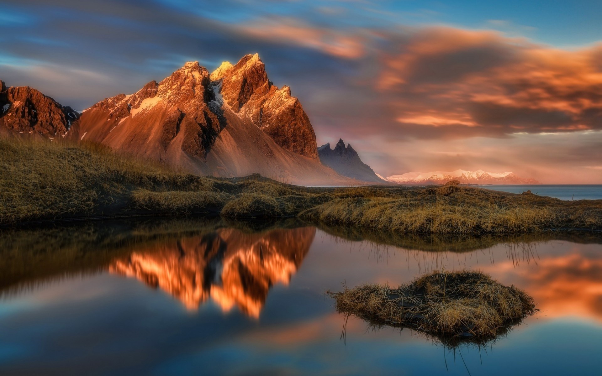 Mountain reflection in a calm lake at sunset HD Wallpaper