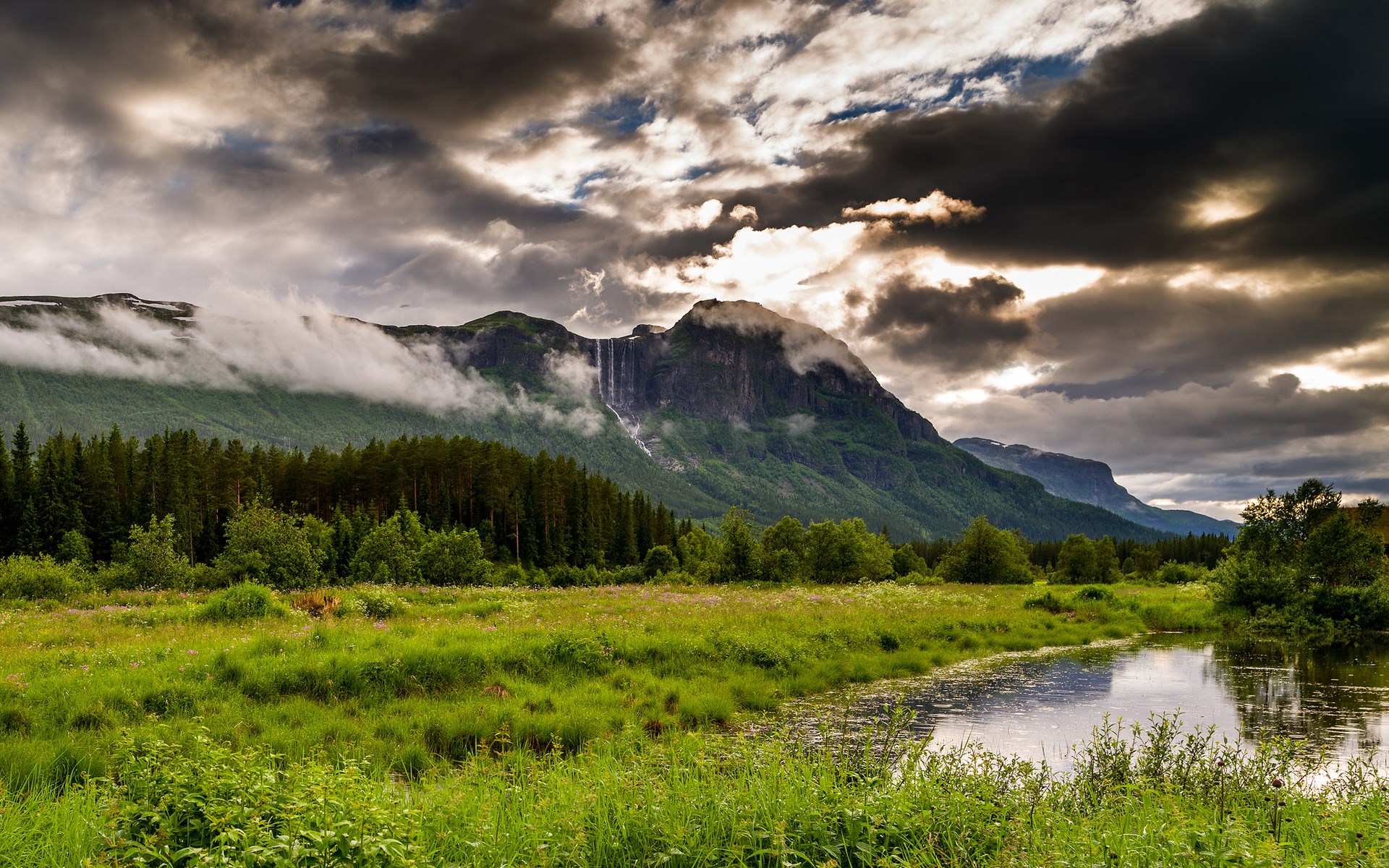 Mountain with waterfall and river in a meadow HD Wallpaper