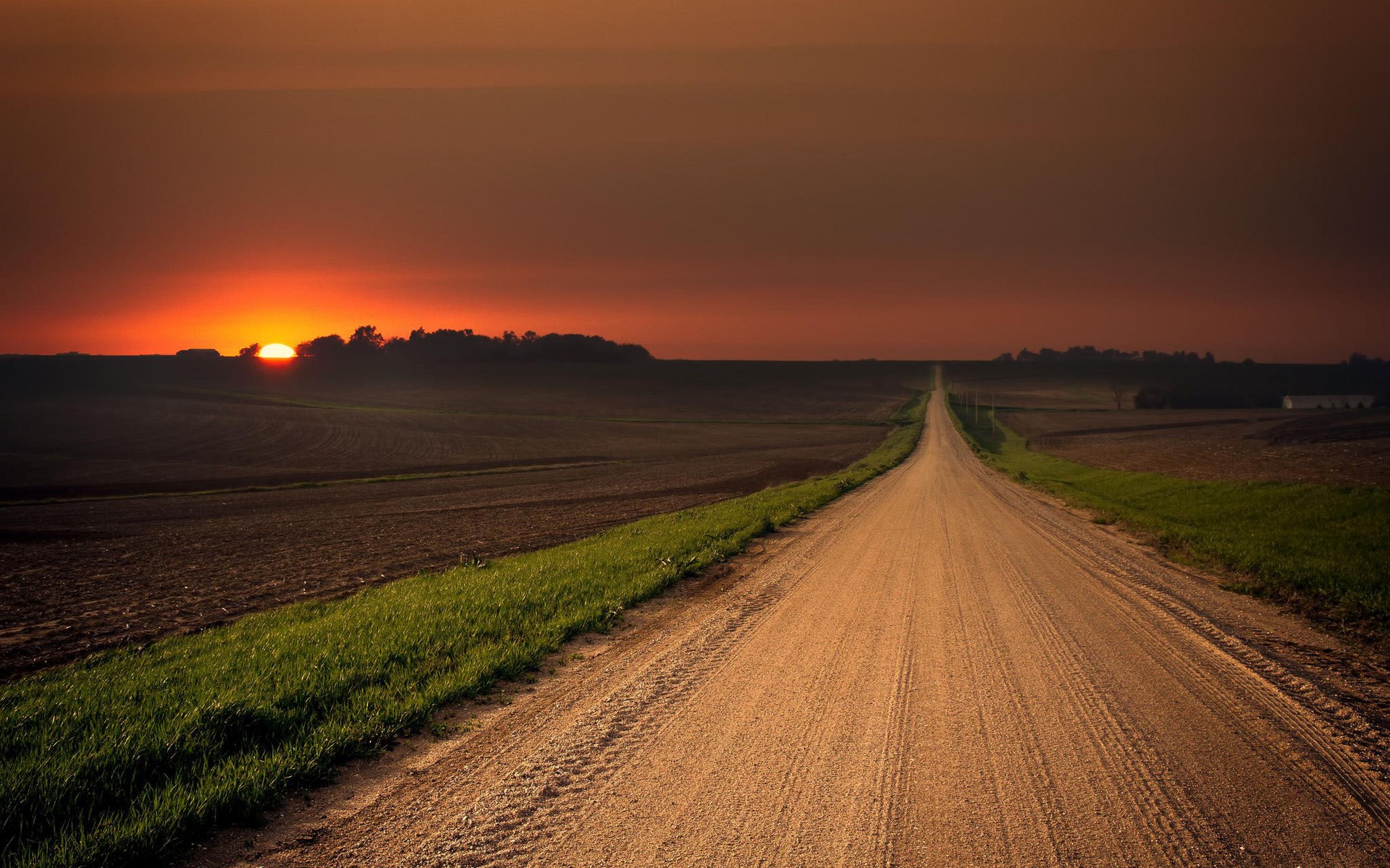 Dirt road through farmland at sunset HD Wallpaper