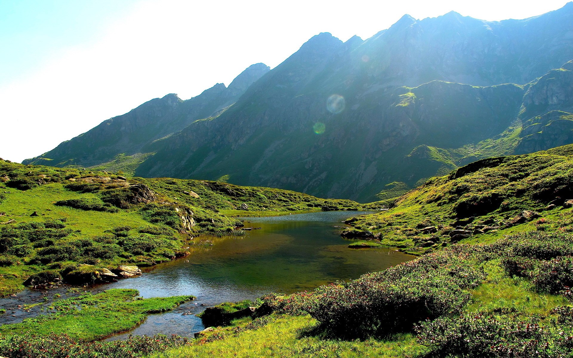 Mountain lake with green hills and rocky peaks HD Wallpaper