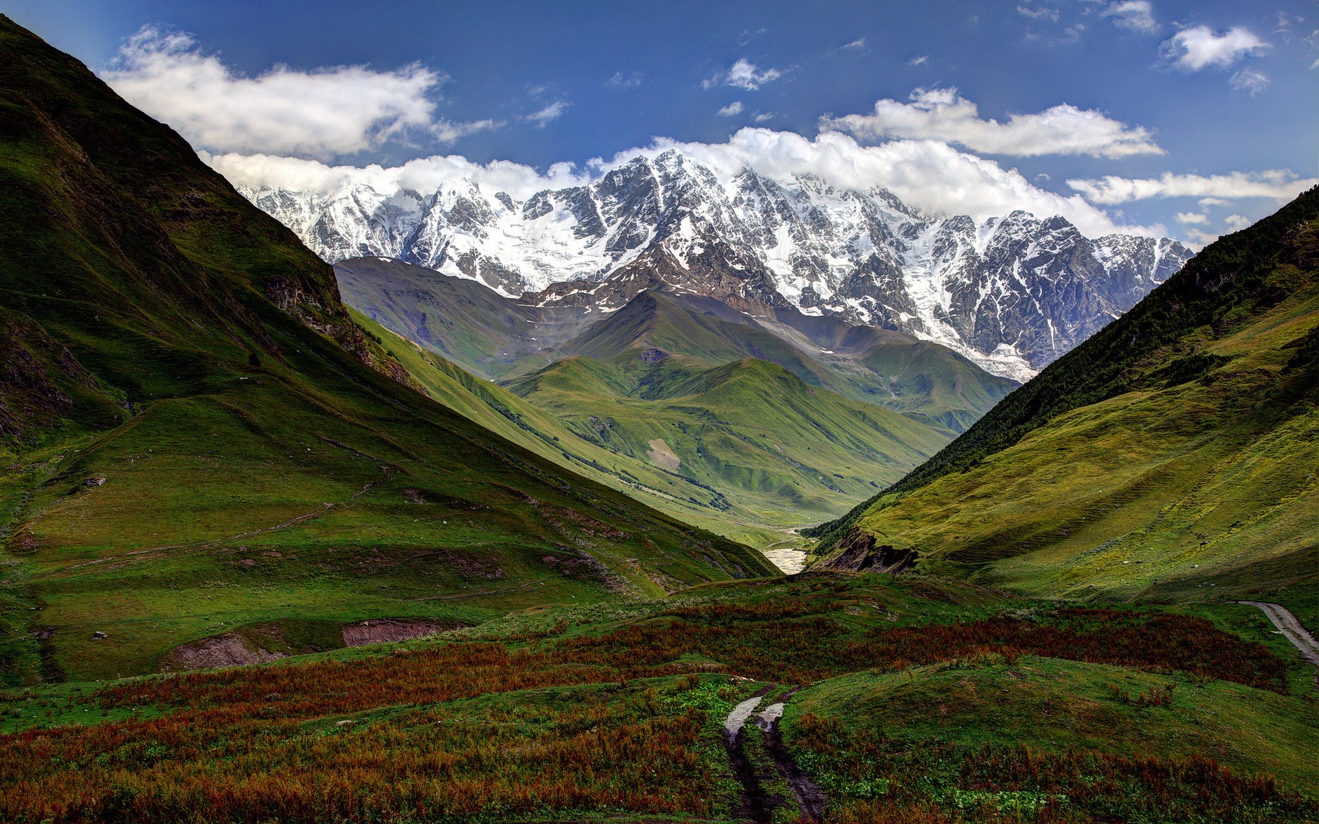 Snow-capped mountains and green valleys HD Wallpaper