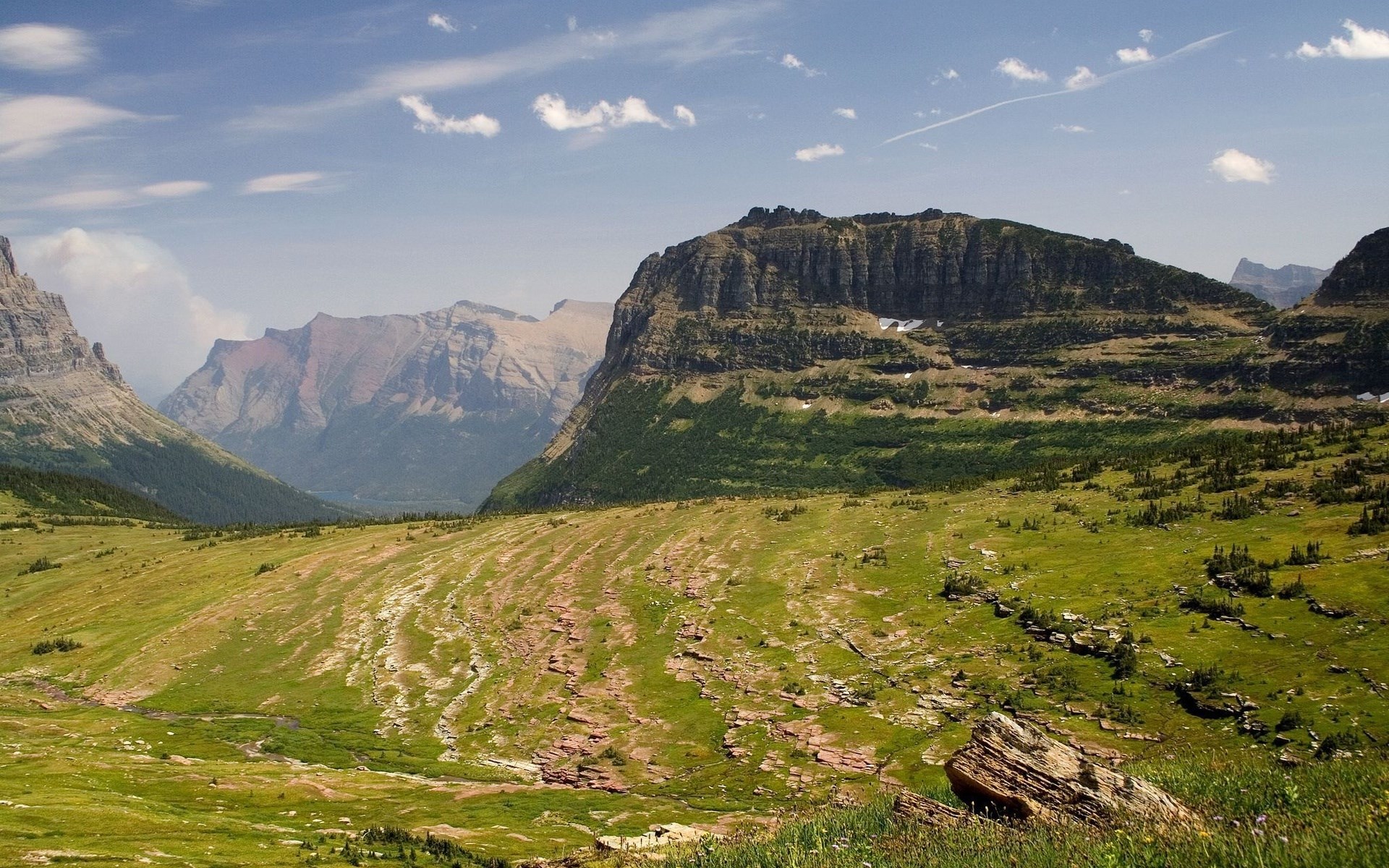 Mountain valley with green hills and rocky slopes HD Wallpaper