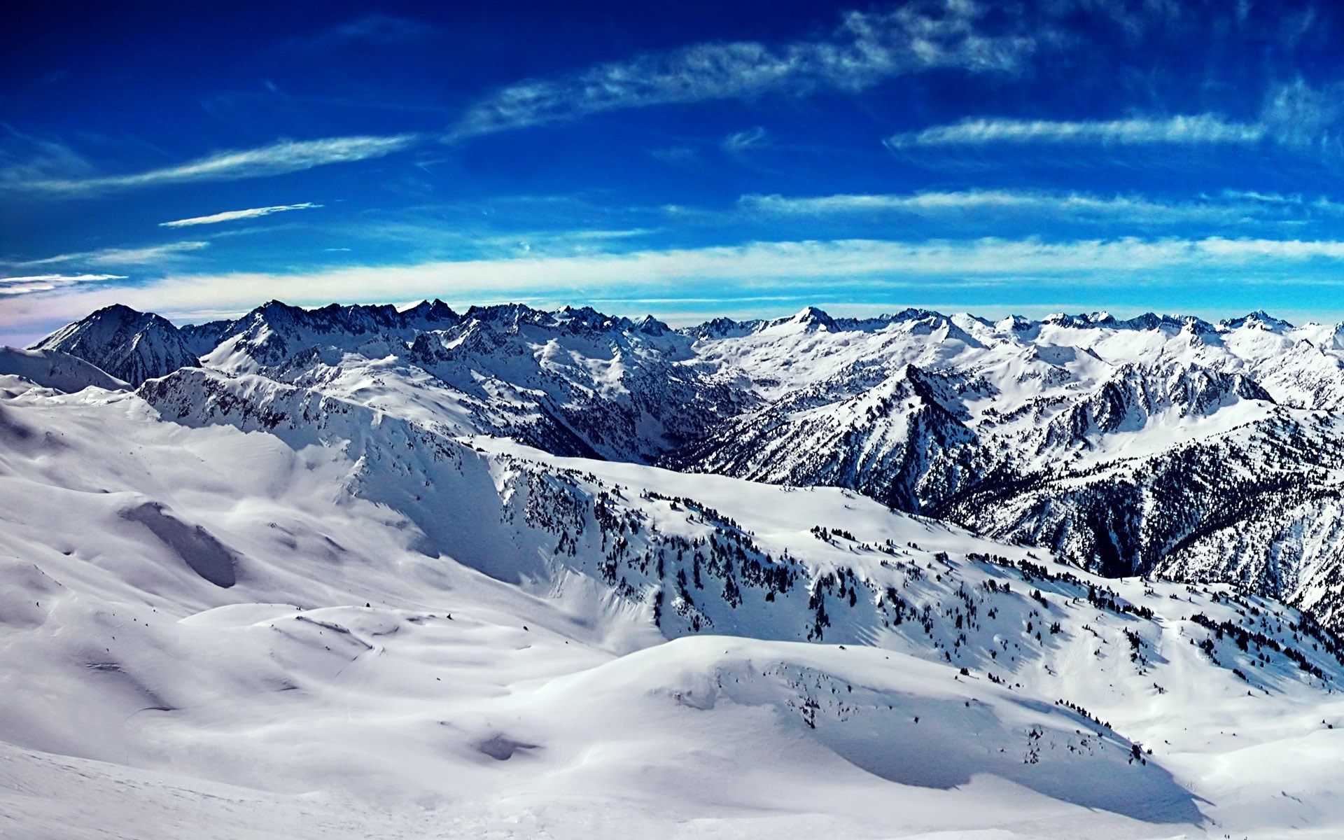 Snowy mountain range under a blue sky HD Wallpaper