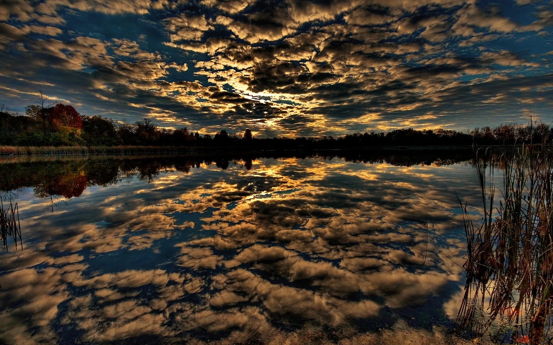 Dramatic sunset clouds reflected in a calm lake HD Wallpaper