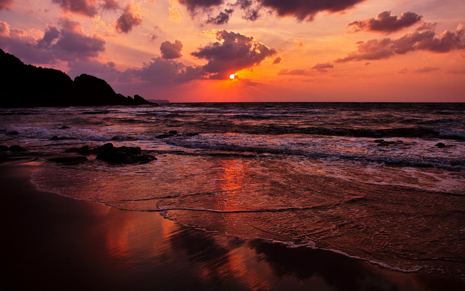 Sunset over the ocean with dramatic clouds and waves HD Wallpaper