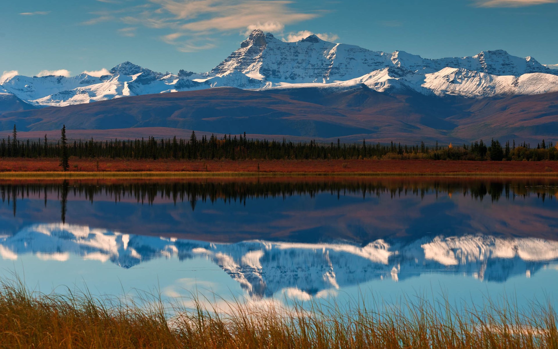 Snow-capped mountains reflected in a calm lake HD Wallpaper