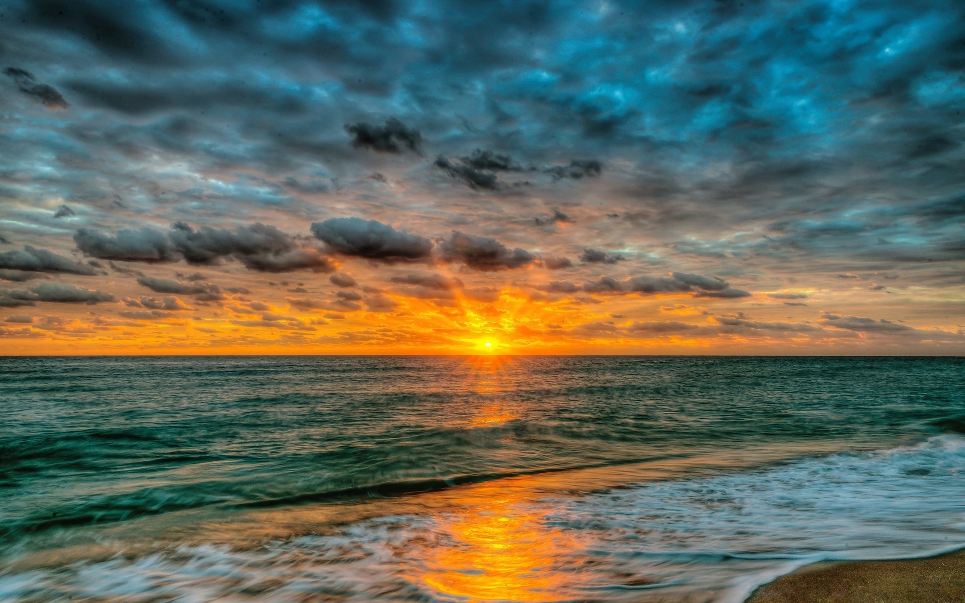 Sunset over the ocean with dramatic clouds HD Wallpaper