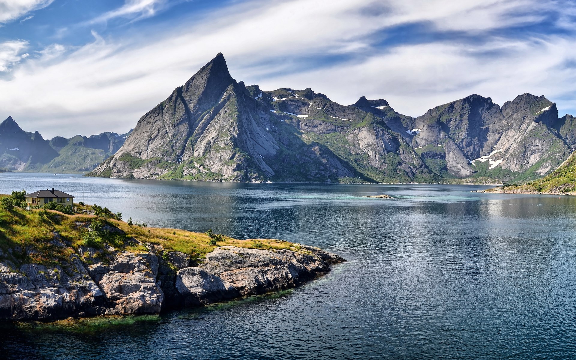 House on a rocky island with mountains and a lake HD Wallpaper