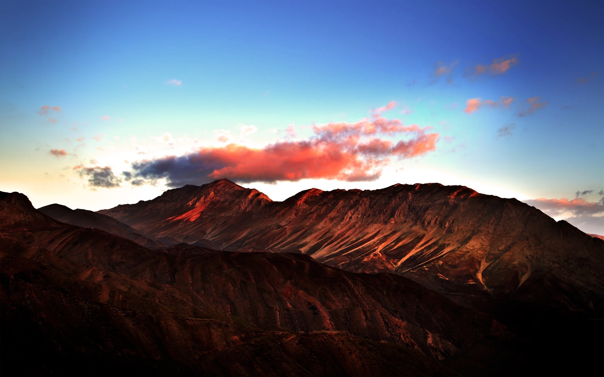 Mountain range at sunset with colorful clouds HD Wallpaper