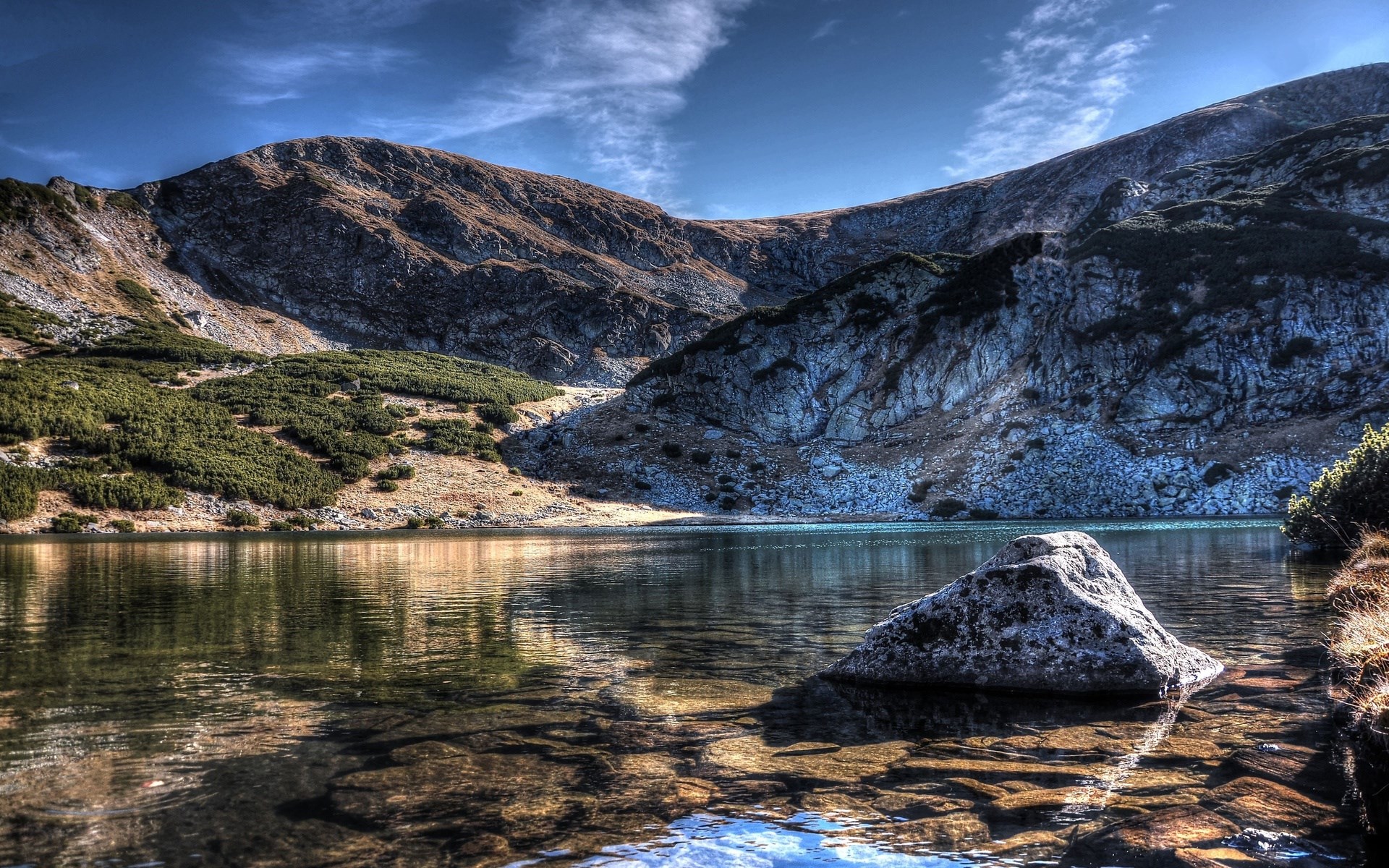 Mountain lake with rocky shore and slopes HD Wallpaper