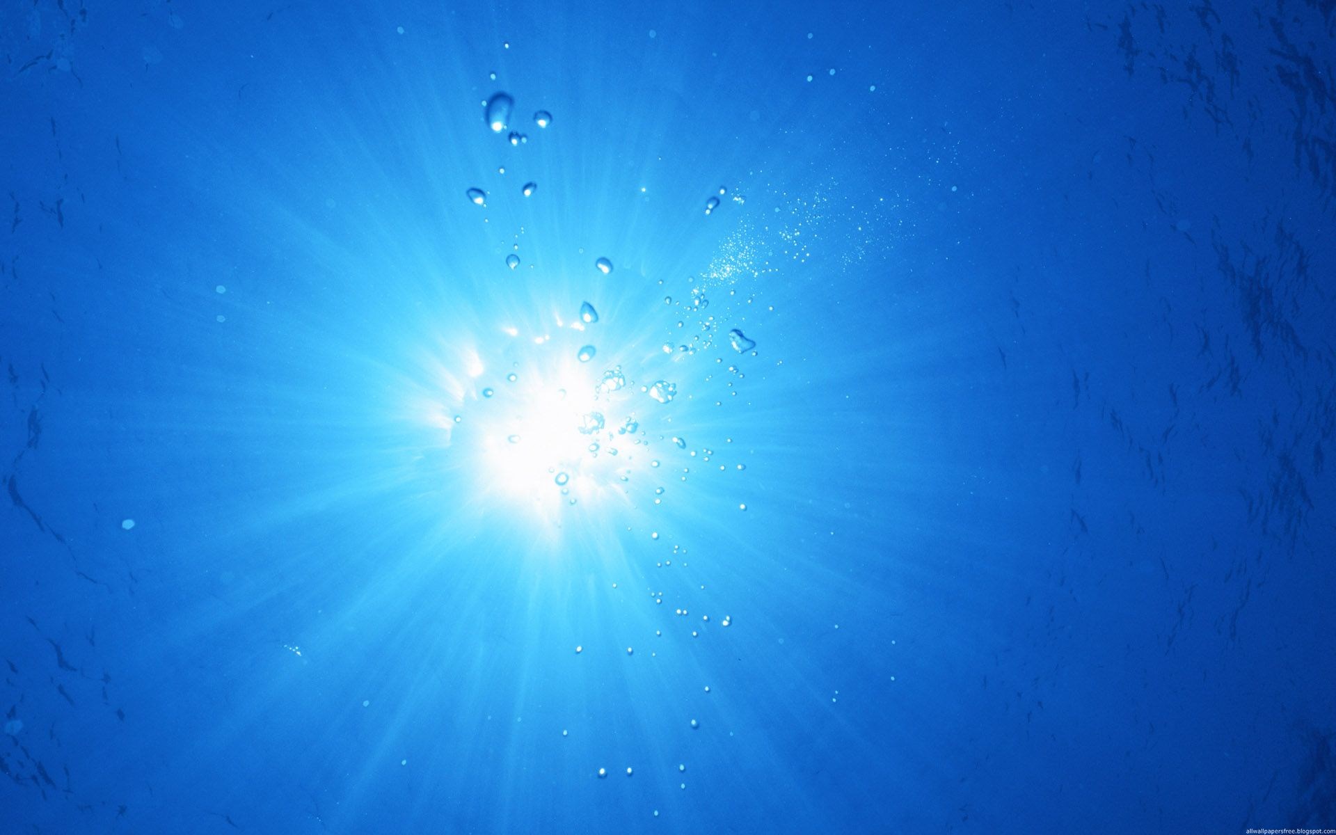 Sunlight shining through blue water with bubbles HD Wallpaper