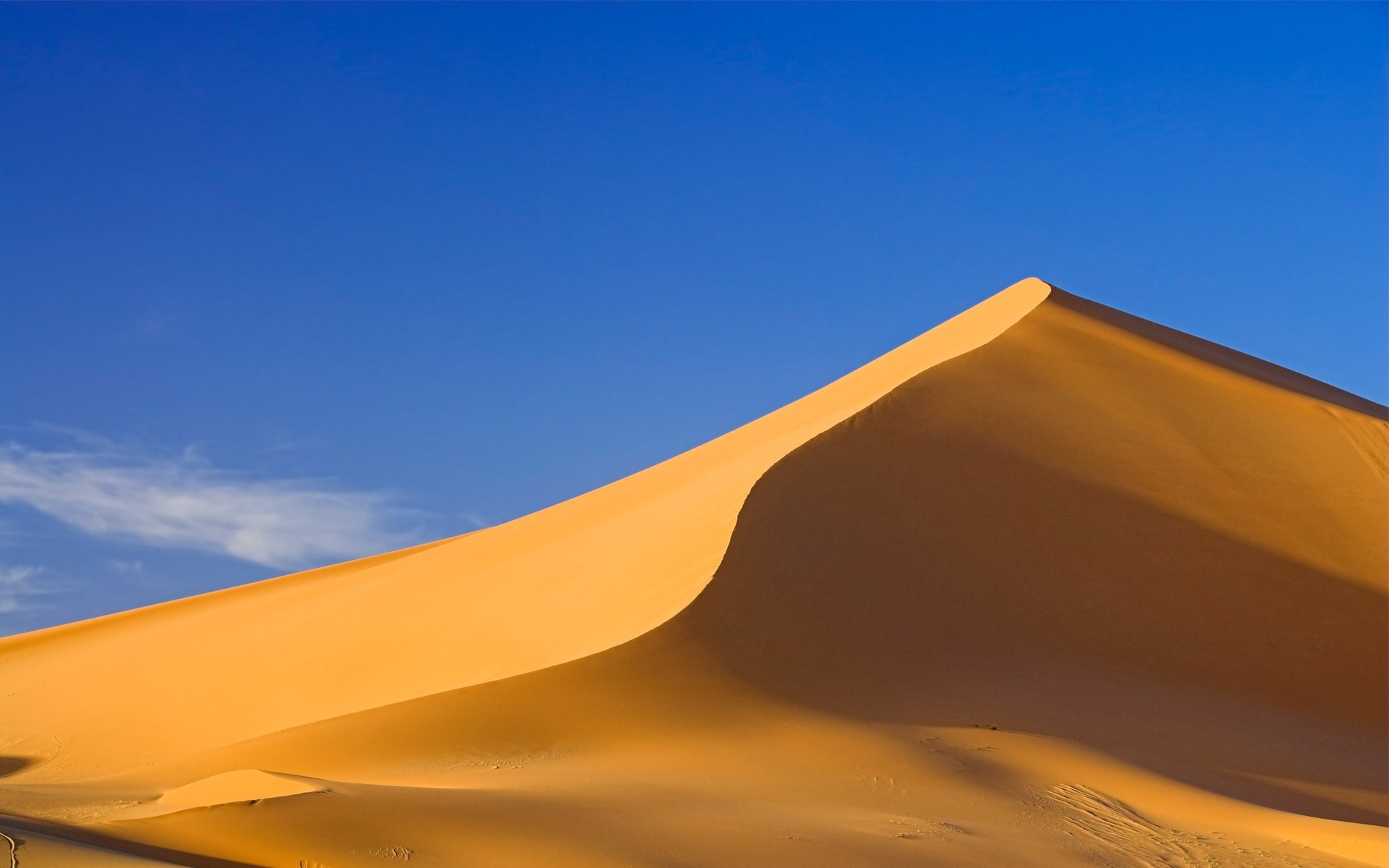Golden sand dune against a clear blue sky HD Wallpaper