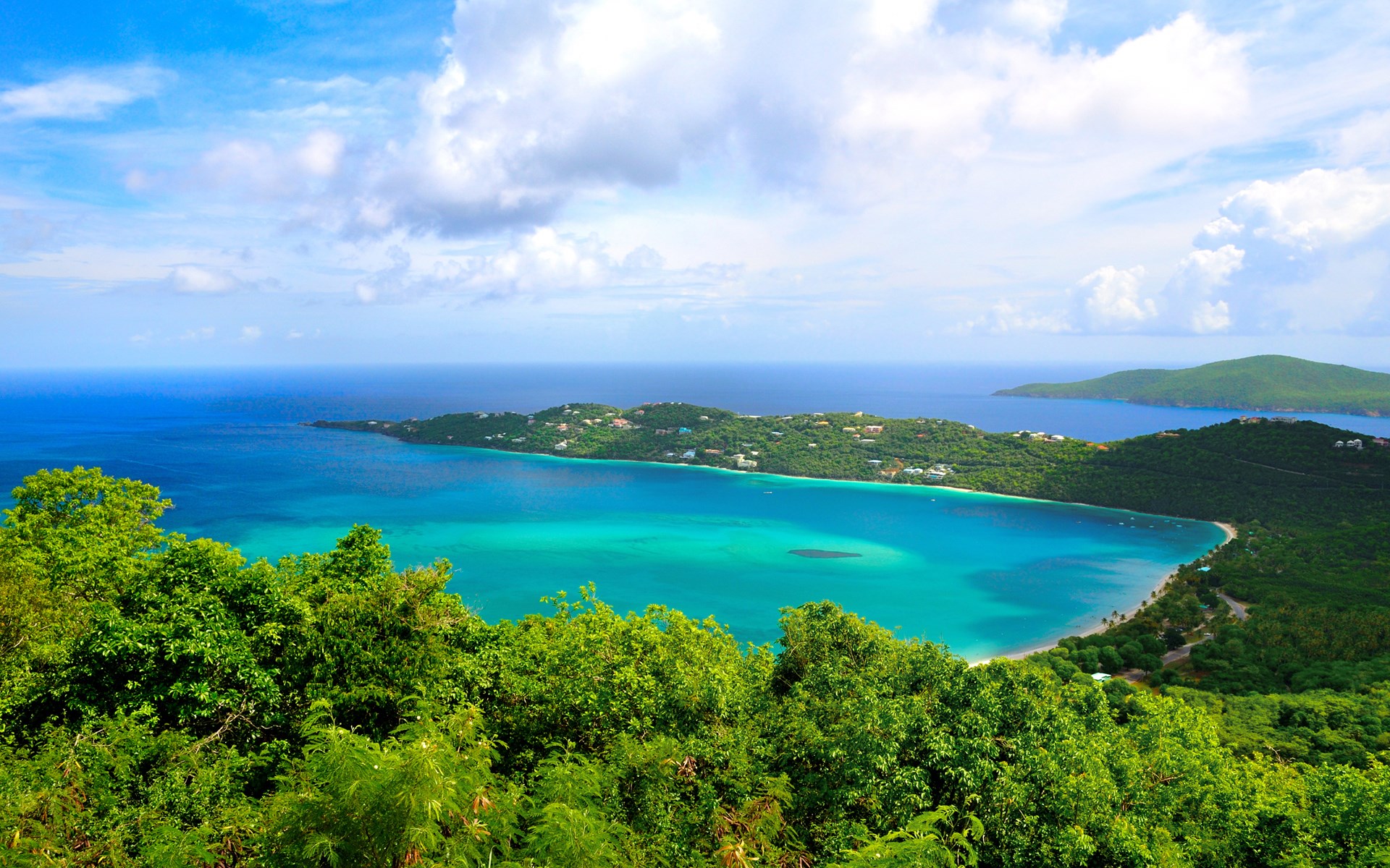 Aerial view of a tropical bay with lush green hills HD Wallpaper