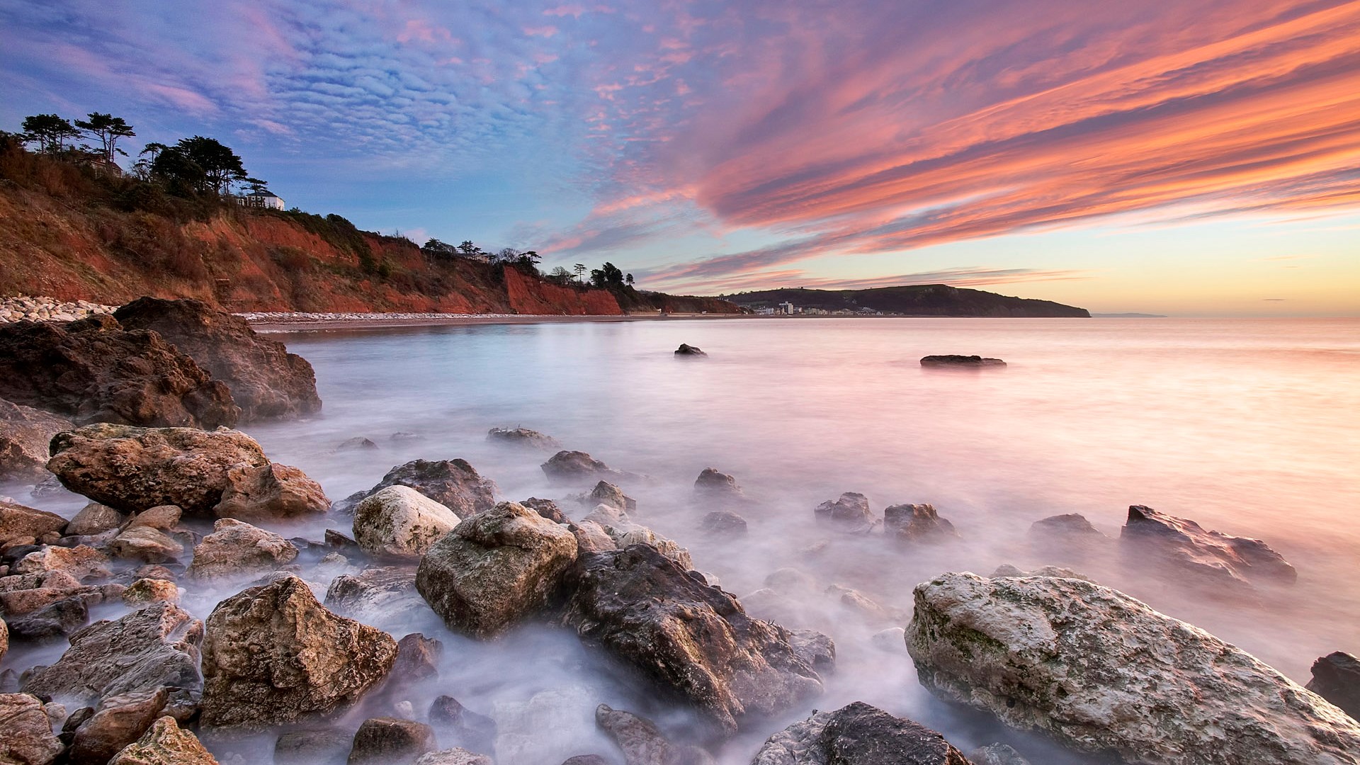 Rocky beach at sunset with colorful clouds HD Wallpaper
