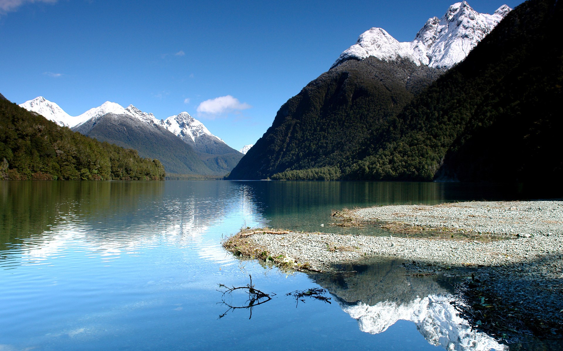 Snow-capped mountains reflected in a clear lake HD Wallpaper