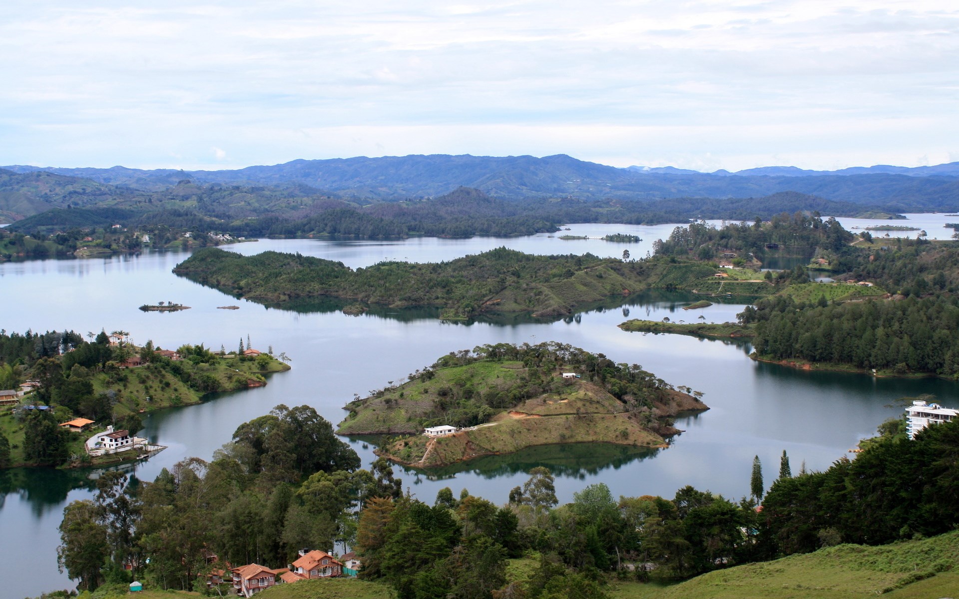 Islands and lakes with houses and mountains HD Wallpaper