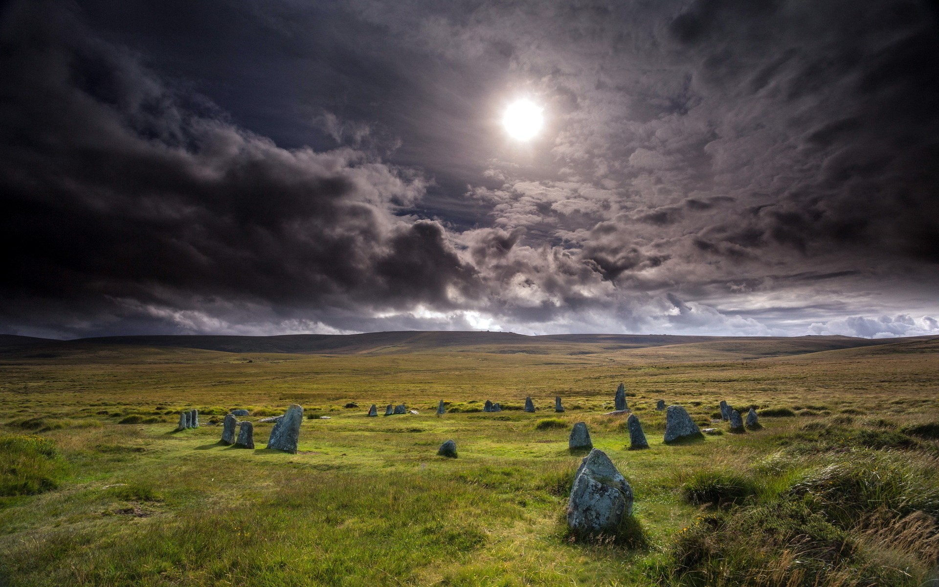 Stone circle on a grassy moor under dramatic sky HD Wallpaper