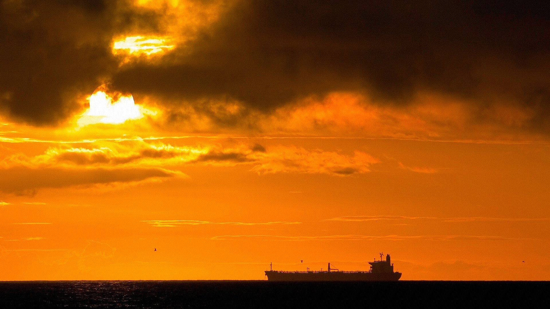 Ship sailing on the ocean during sunset HD Wallpaper