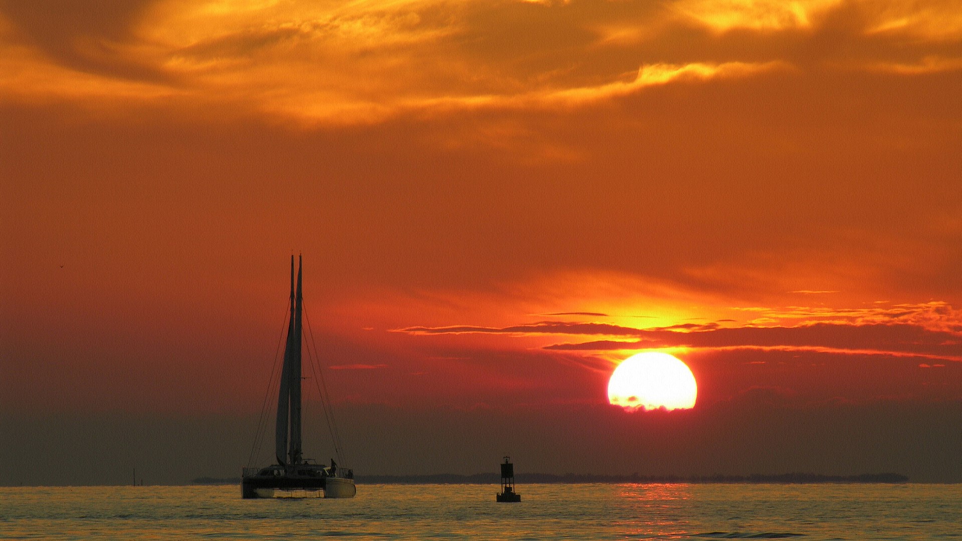 Sailboat and buoy at sunset over the ocean HD Wallpaper