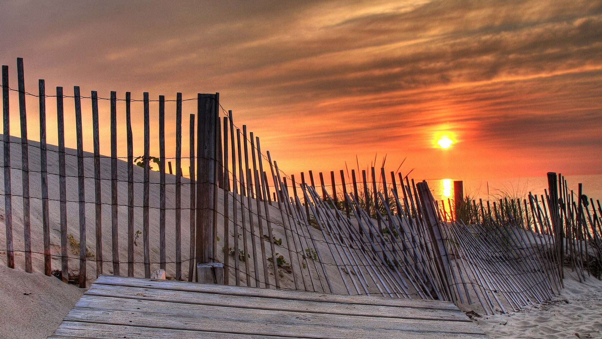 Beach fence and boardwalk at sunset HD Wallpaper