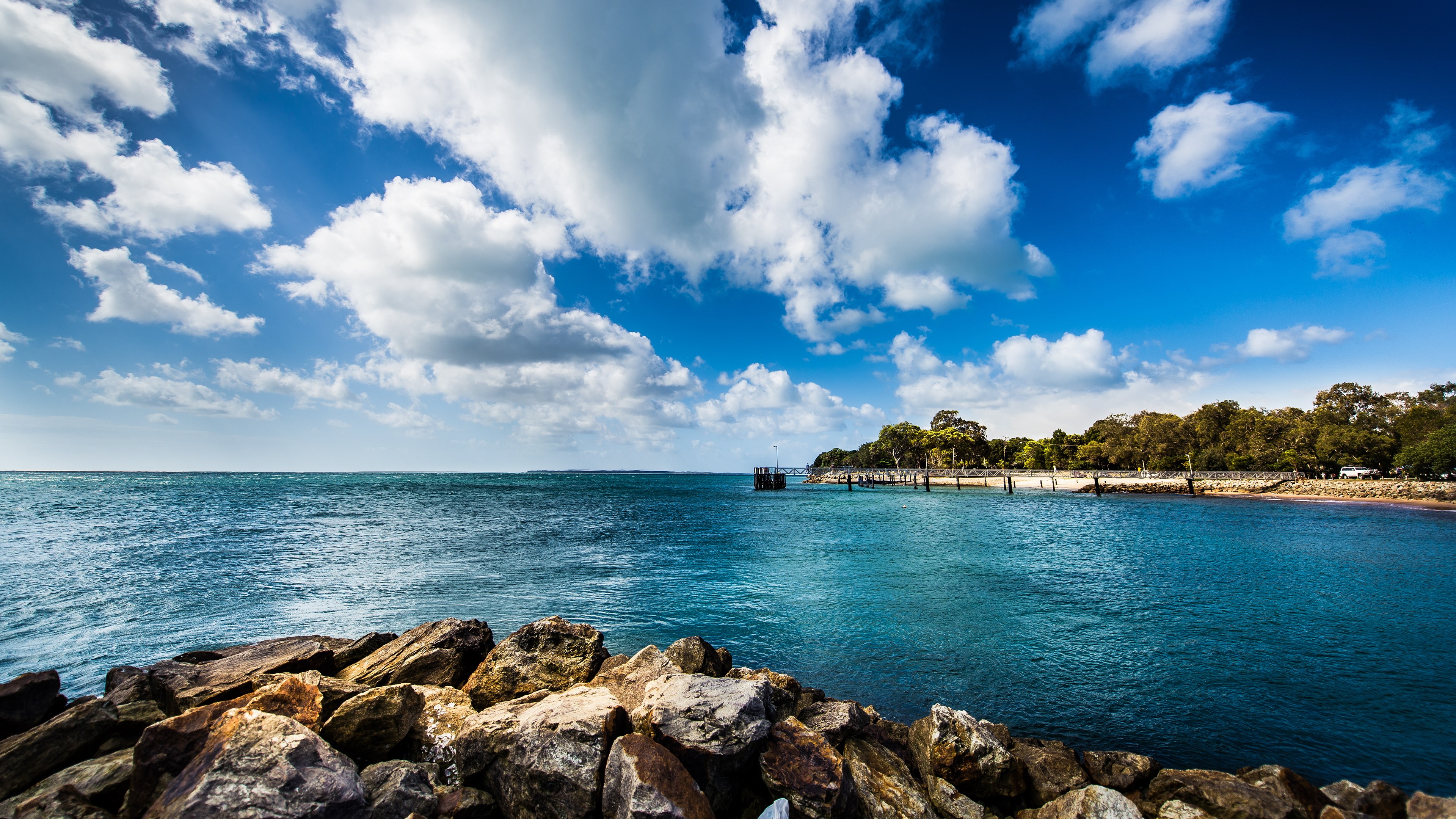 Ocean view with pier and trees HD Wallpaper