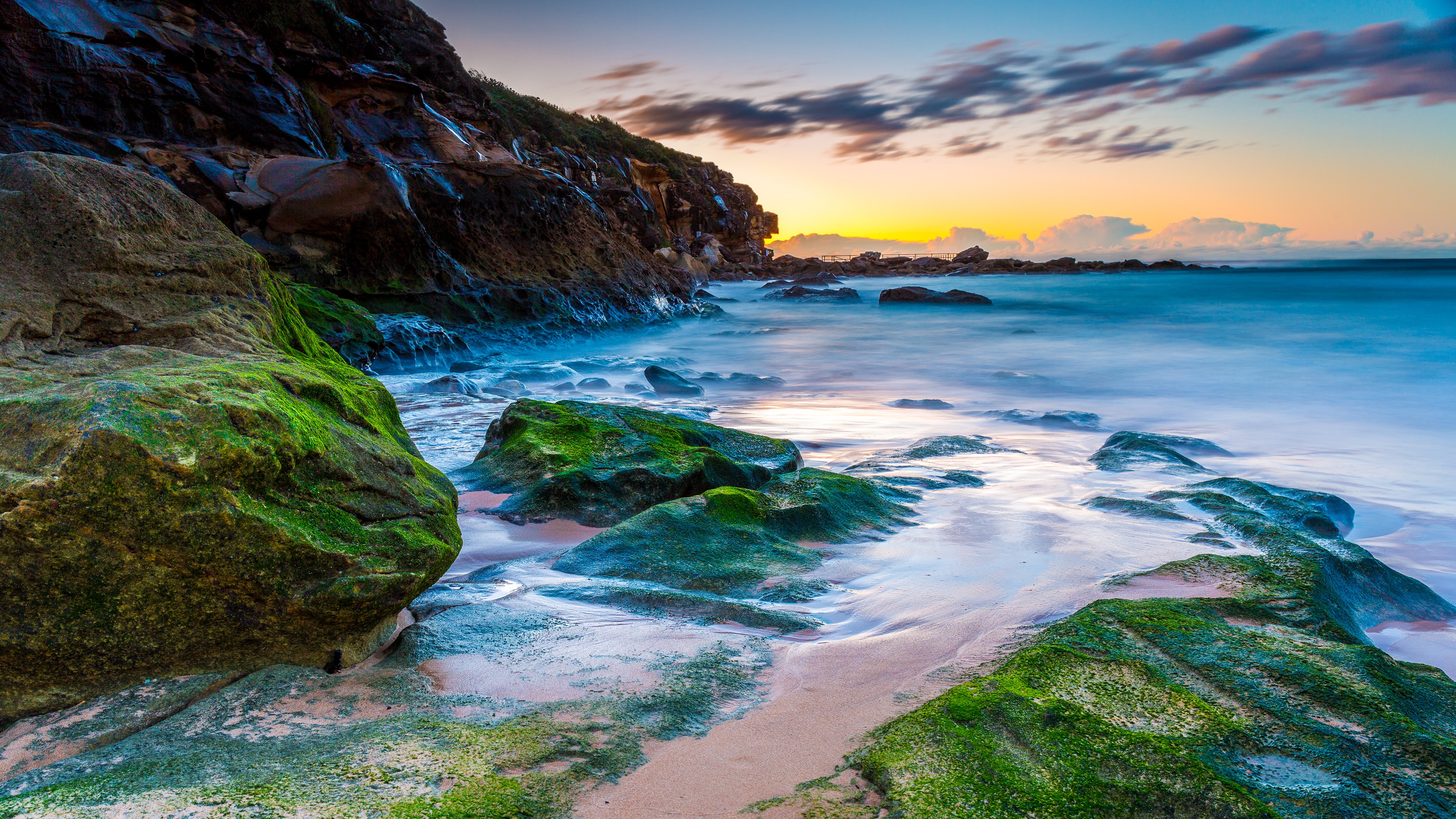 Mossy rocks on a beach at sunrise HD Wallpaper