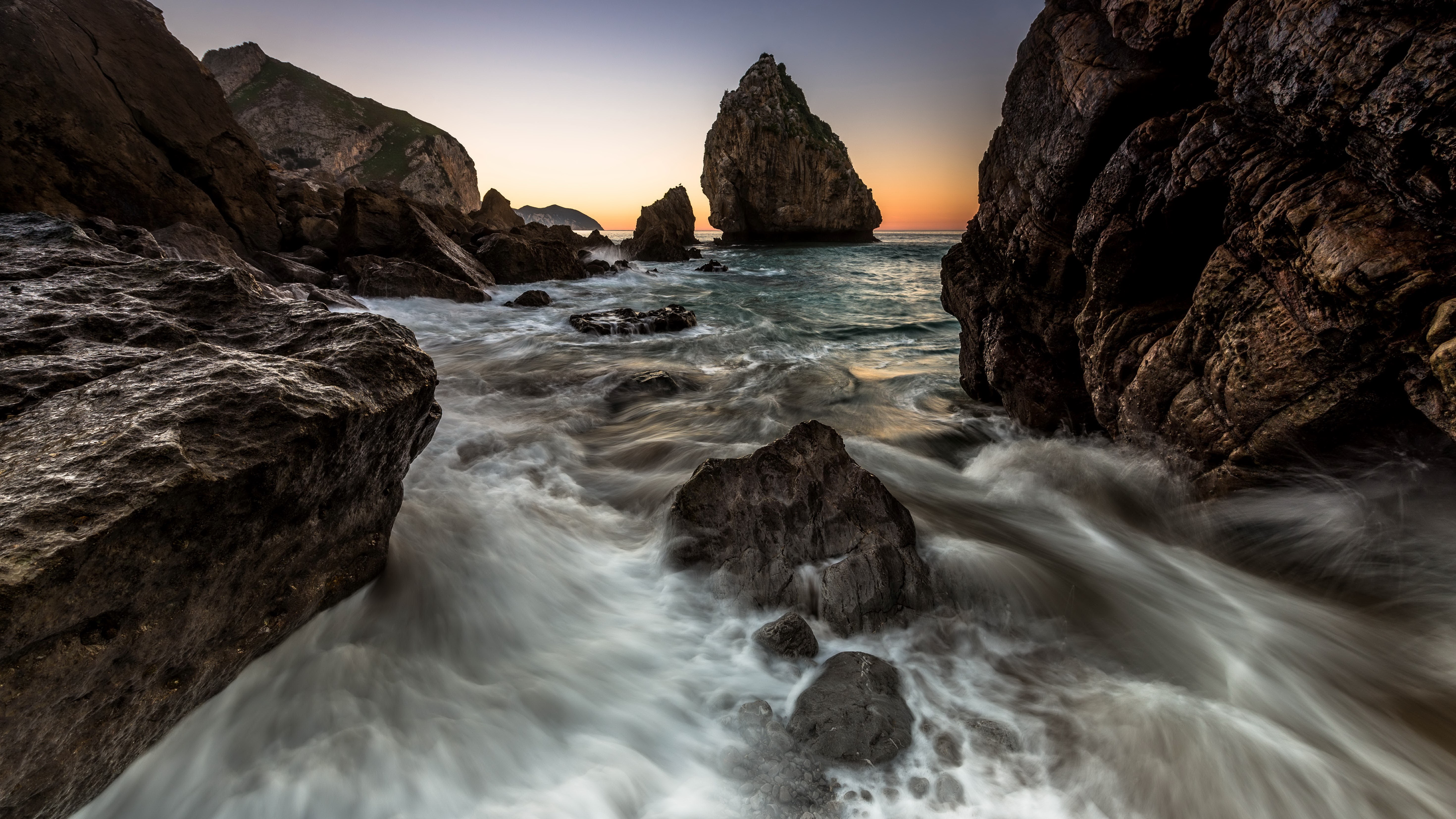 Rocky coastline with waves at sunset HD Wallpaper
