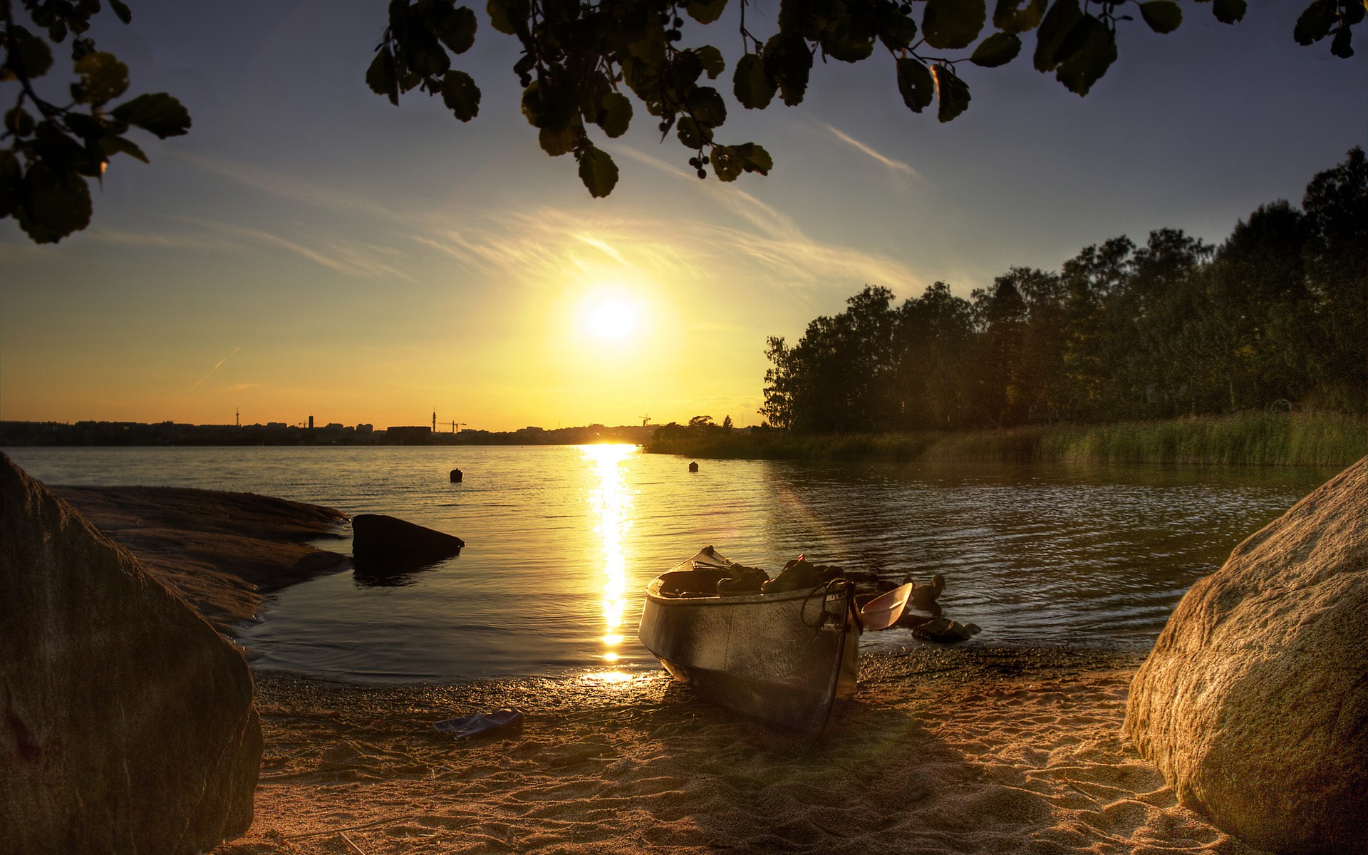 Boat on a beach at sunset with city skyline HD Wallpaper