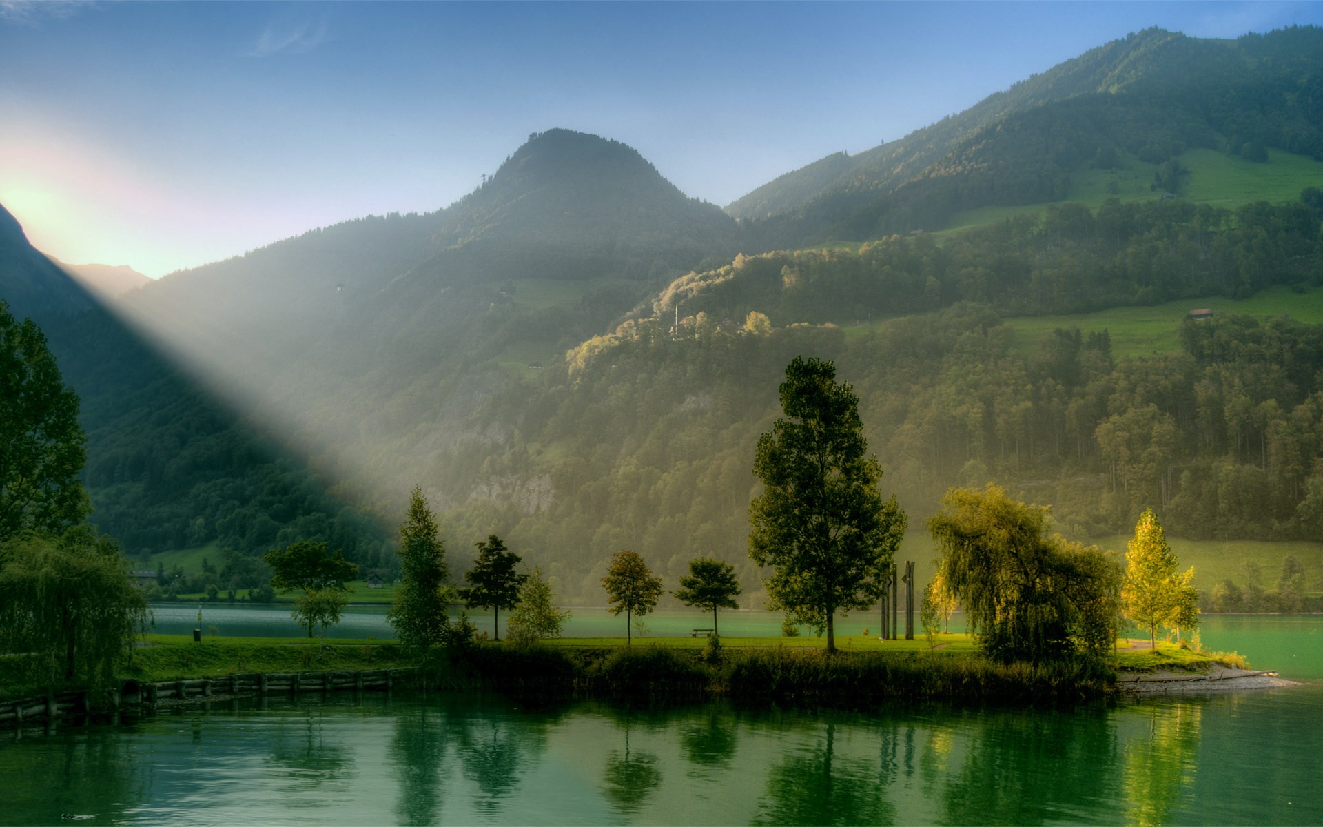 Sunbeams over a lake and mountains HD Wallpaper
