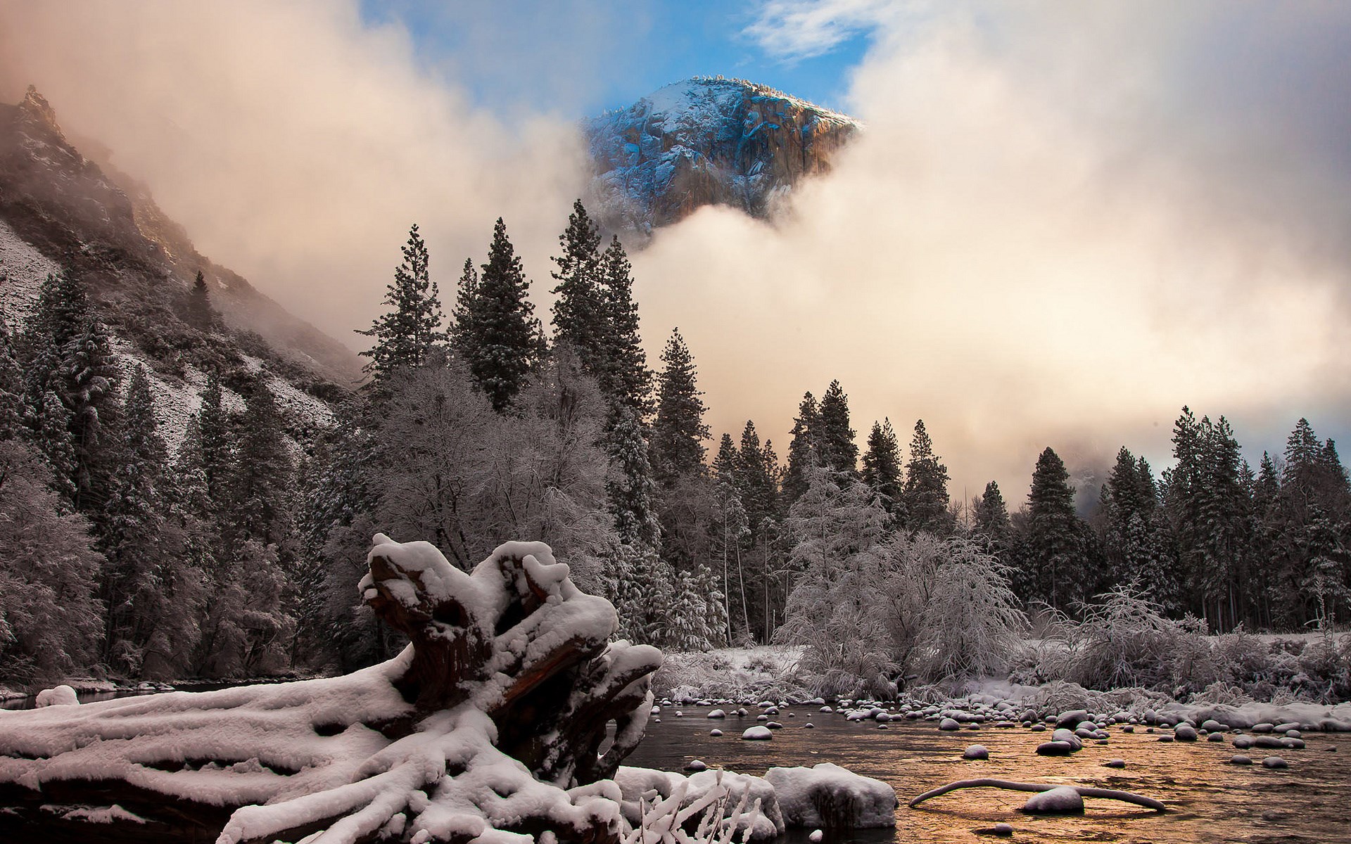 Snowy Yosemite Valley with El Capitan peeking through clouds HD Wallpaper
