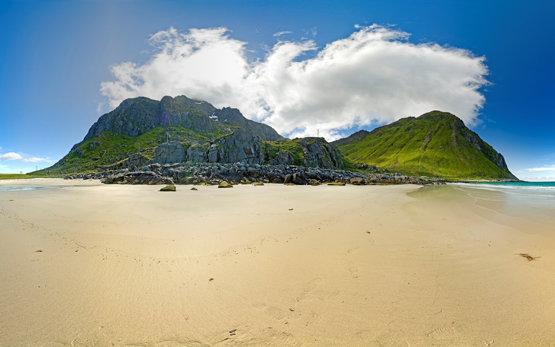 Sandy beach with green mountains and blue sky HD Wallpaper