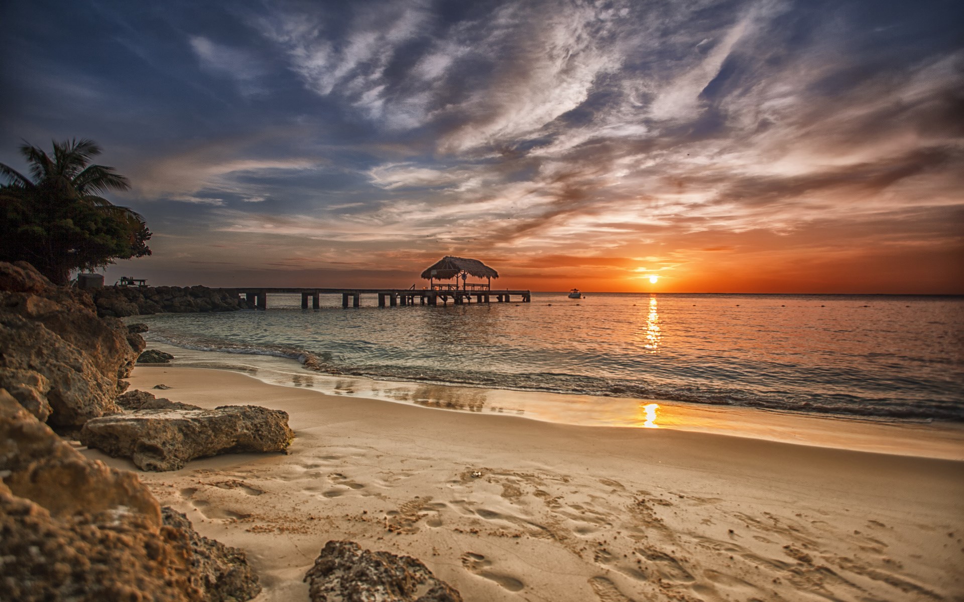 Sunset over a tropical beach with a pier HD Wallpaper
