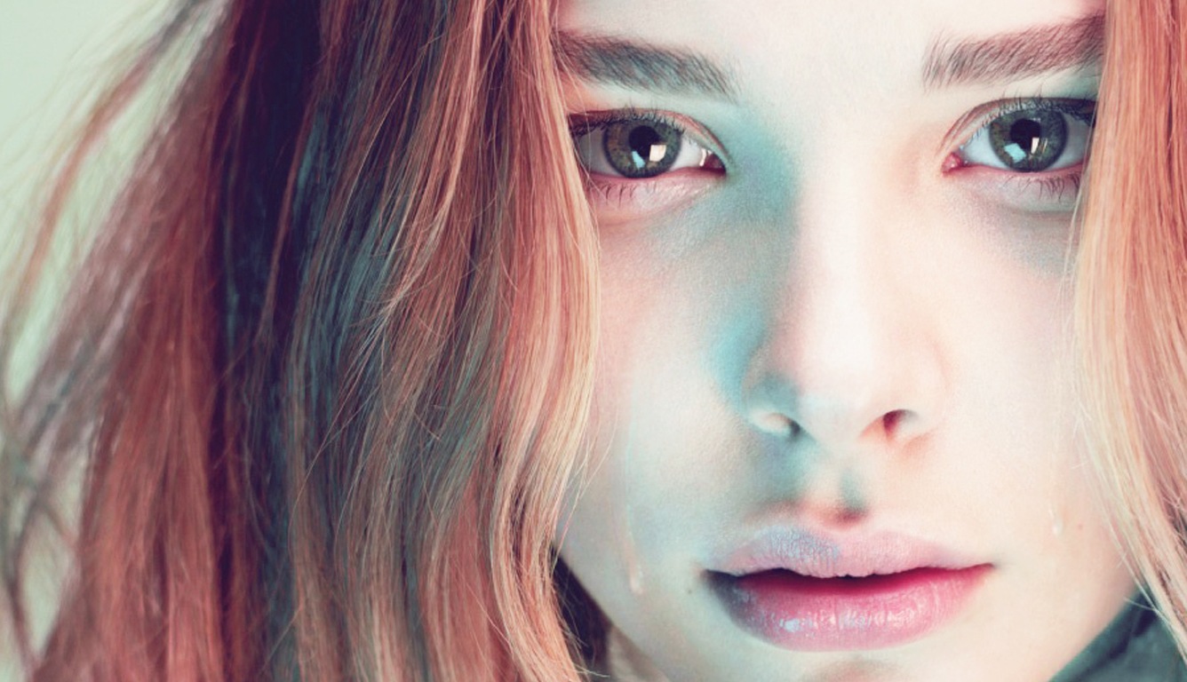 Close-up of Chloe Grace Moretz with Soft Lighting and Tear HD Wallpaper