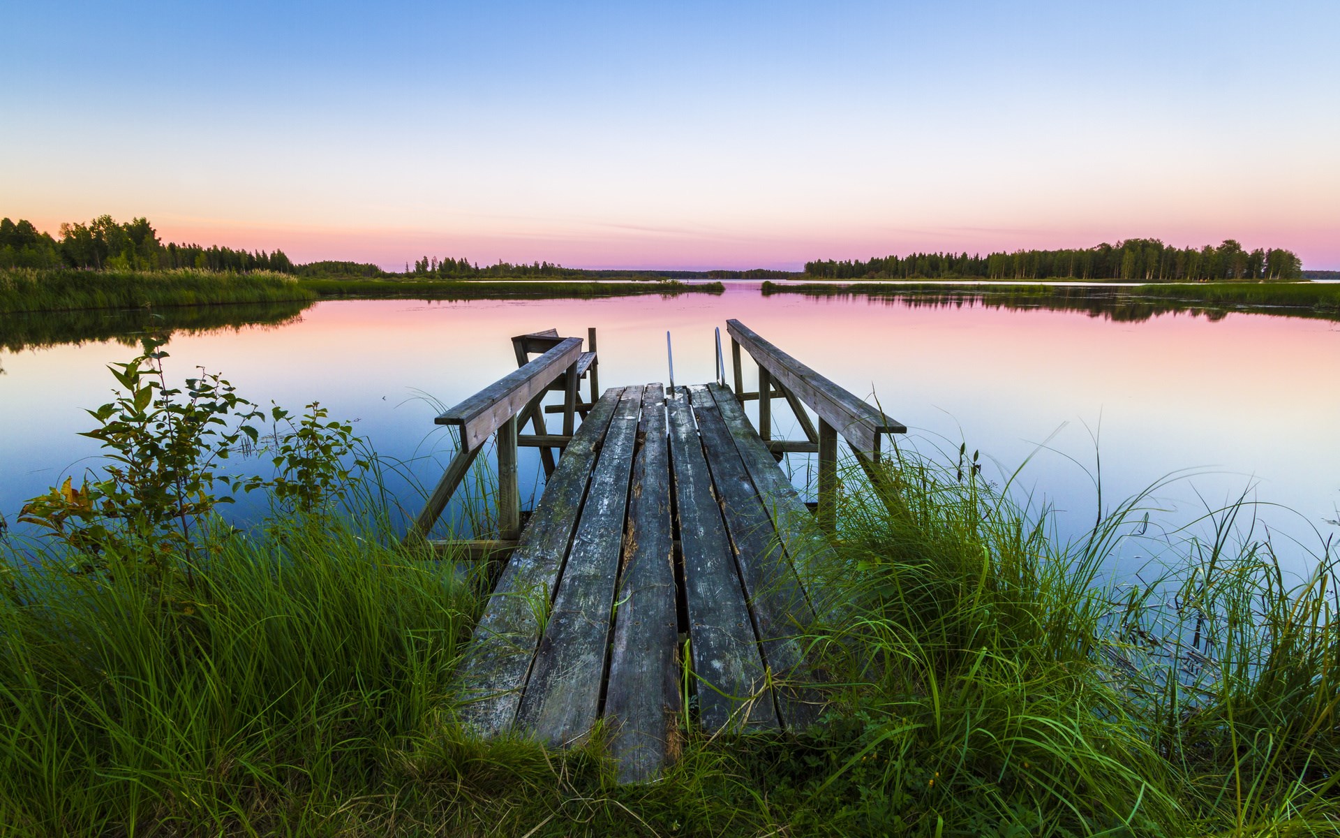 Wooden dock on a calm lake at sunset HD Wallpaper