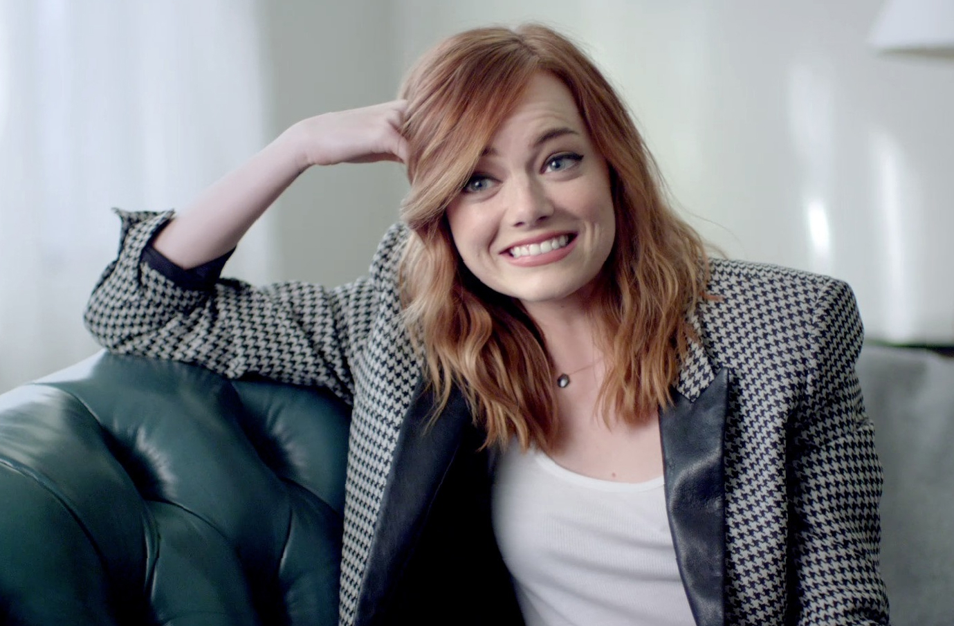 Emma Stone sitting on a couch HD Wallpaper