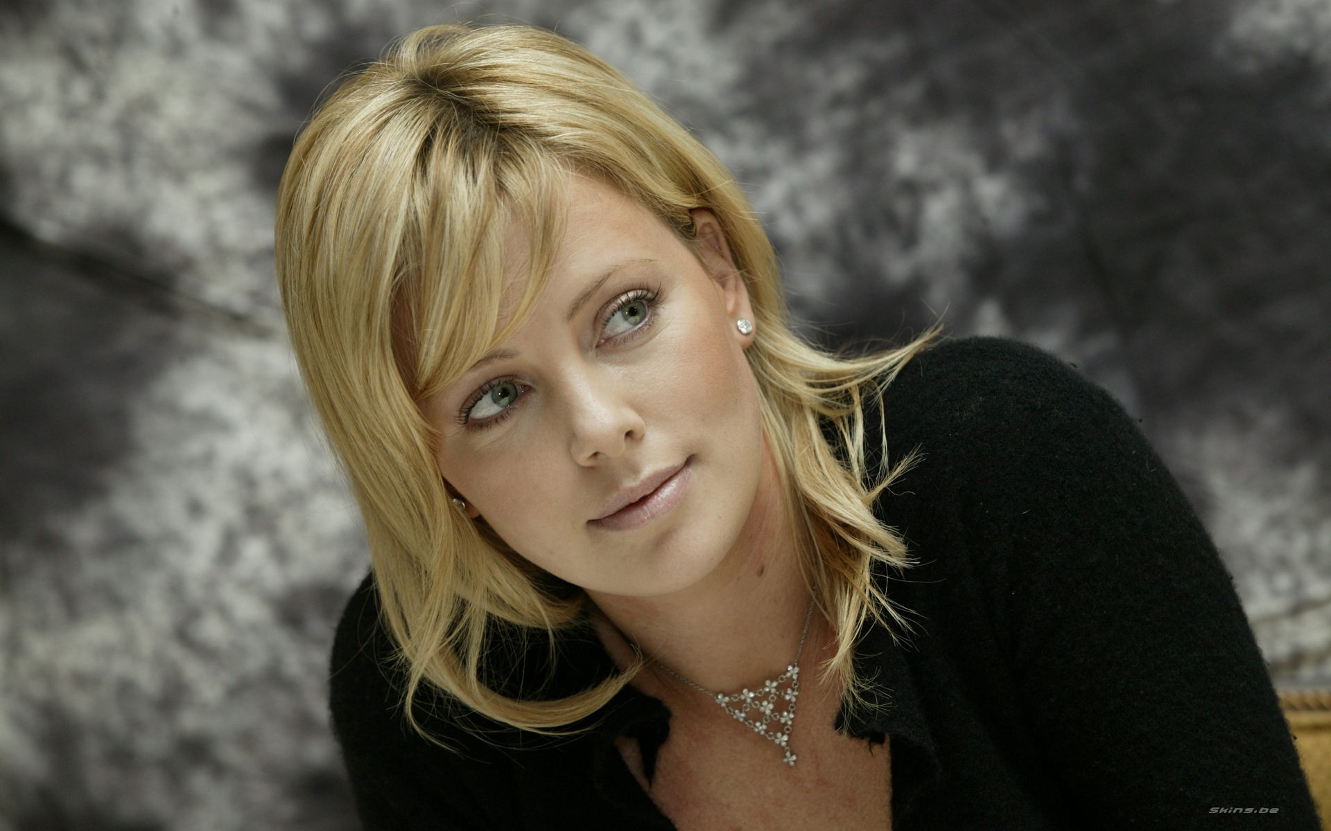 Charlize Theron in Black Sweater with Soft Expression HD Wallpaper