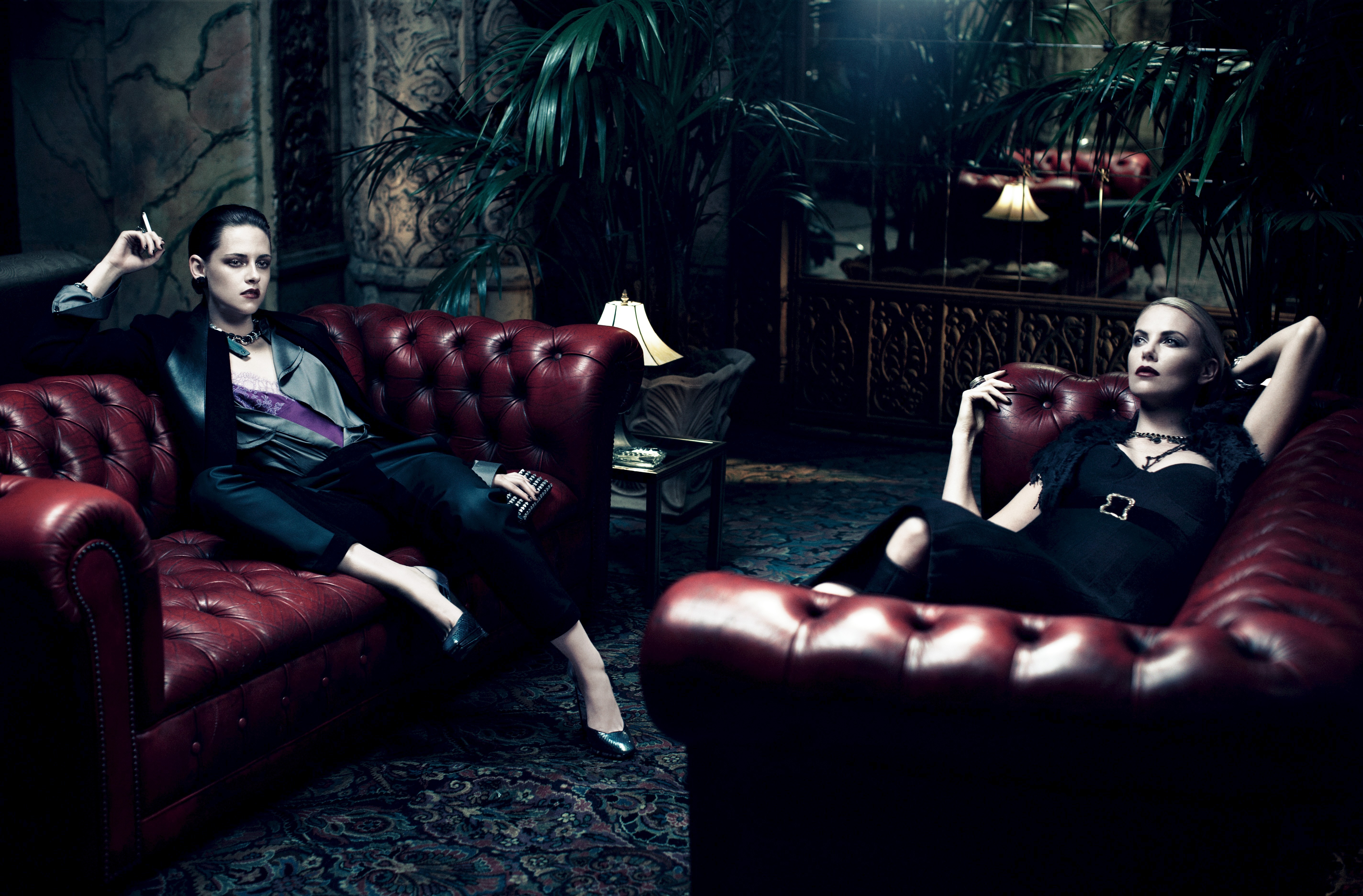 Kristen Stewart and Charlize Theron on couches HD Wallpaper
