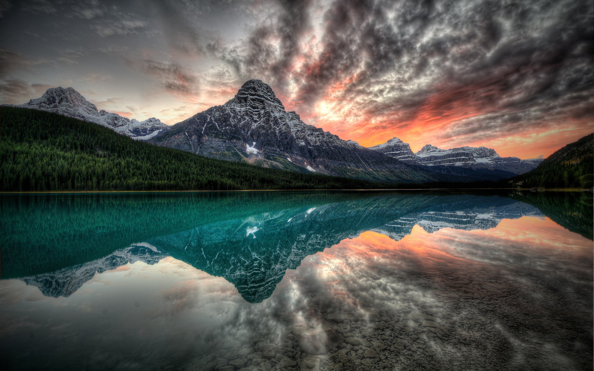 Mountain reflected in a lake at sunset HD Wallpaper