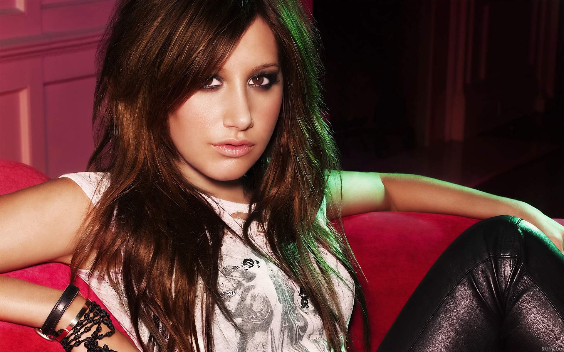 Ashley Tisdale on a red couch HD Wallpaper