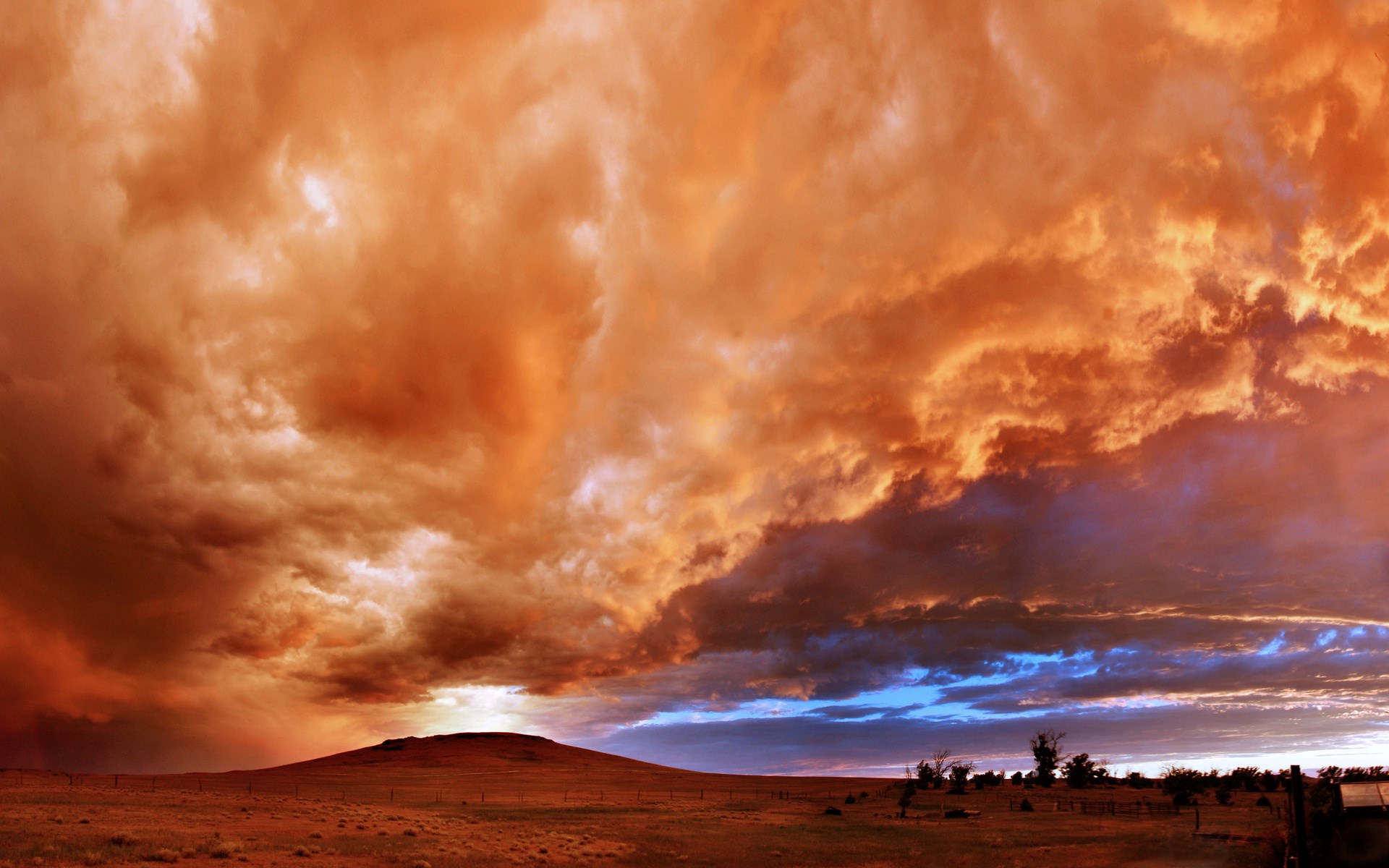 Dramatic sunset clouds over a prairie landscape HD Wallpaper