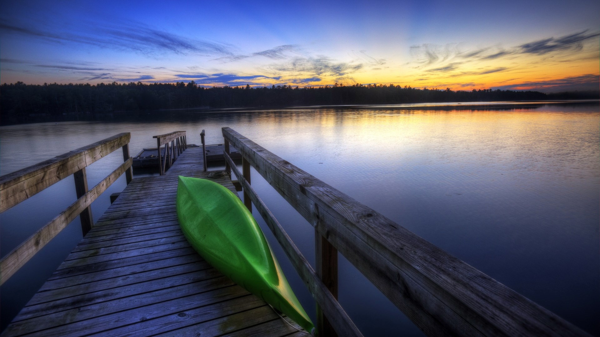 Canoe on a dock at sunset over a lake HD Wallpaper