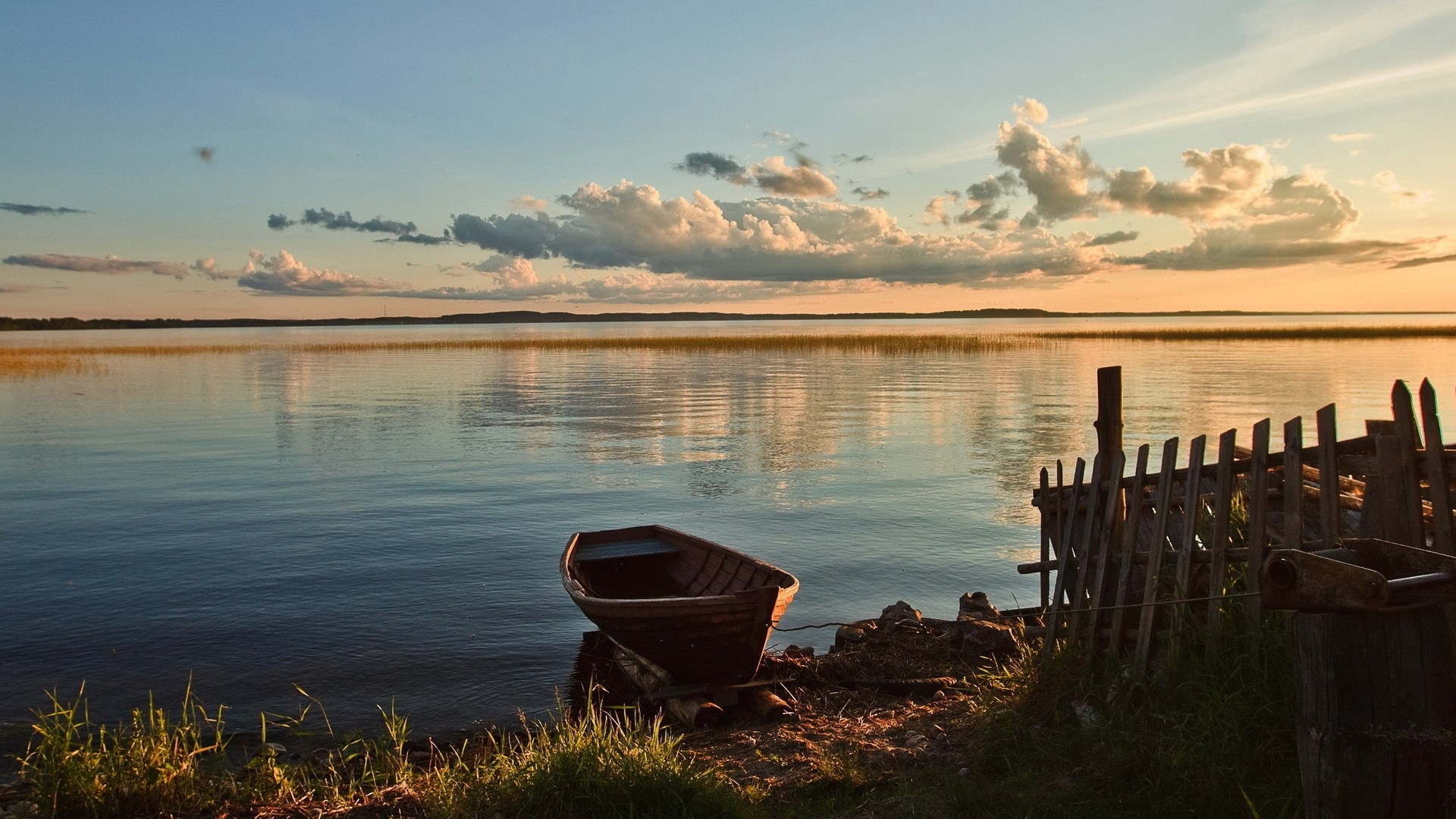 Boat on a lake at sunset with clouds HD Wallpaper
