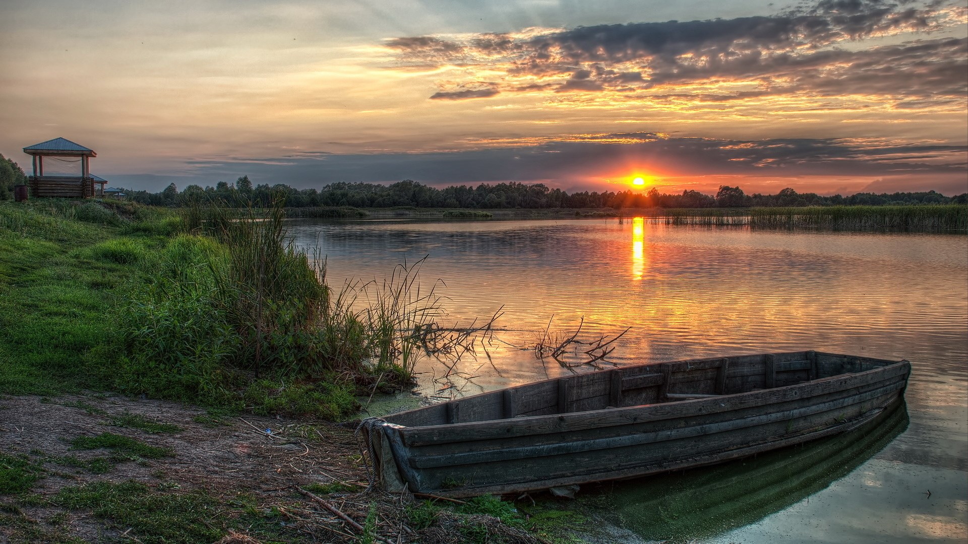 Wooden boat on a lake at sunset HD Wallpaper